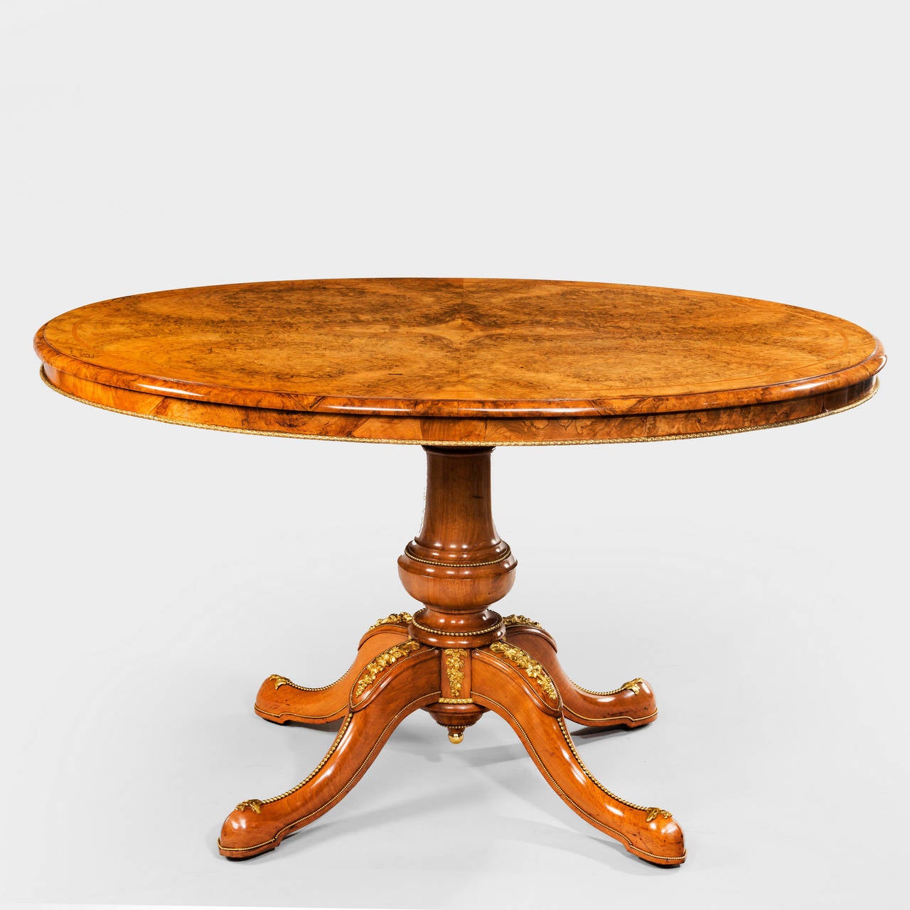 An exhibition quality burr walnut and ormolu-mounted centre table with superb quartered veneered top. Attributed to Holland and Sons or Gillows.