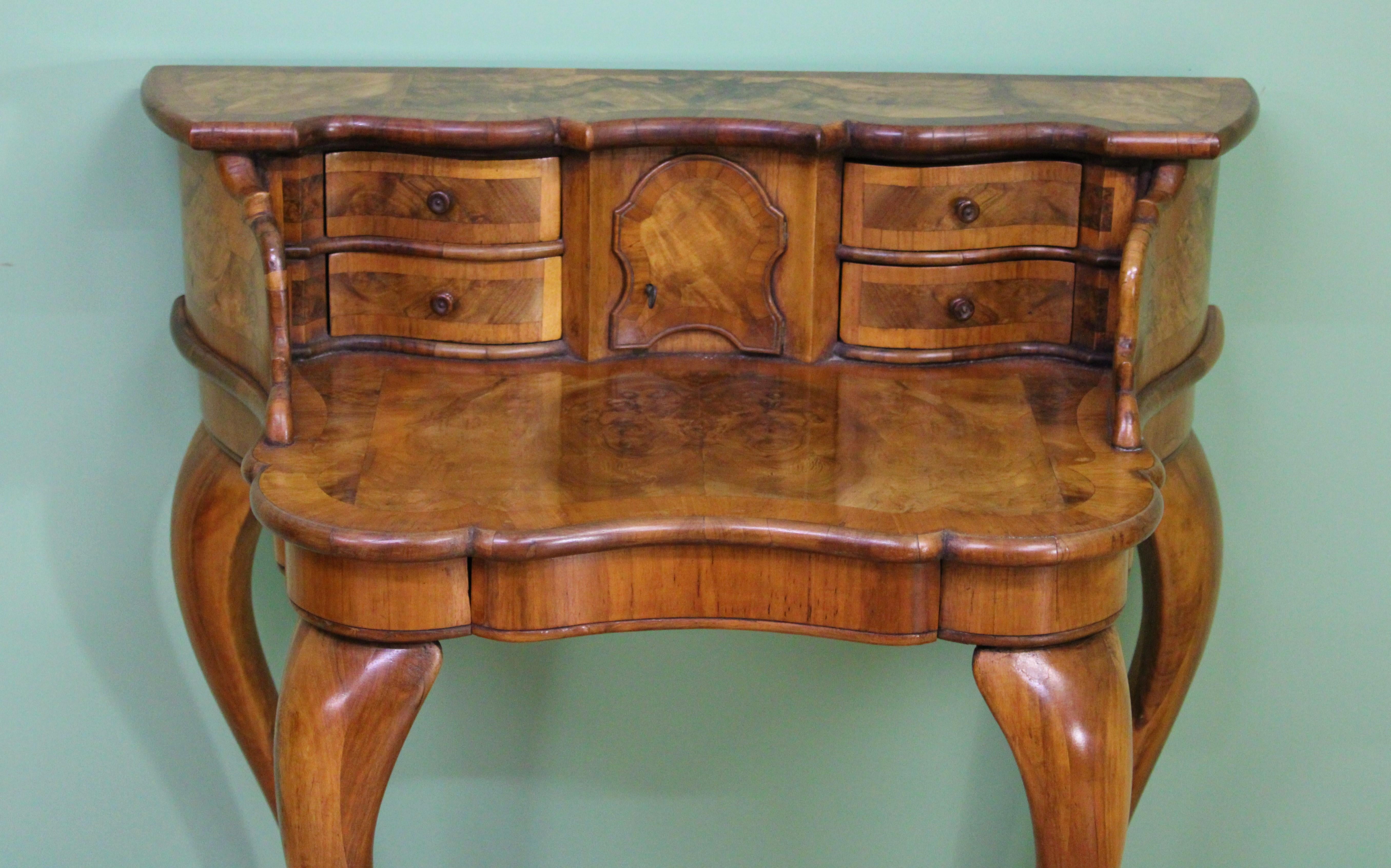 A charming and unusual burr walnut Bonheur du jour. Of very good construction in solid walnut with attractive burr walnut veneers onto an oak carcas. The superstructure with a series of stationary drawers and a central small cupboard (lockable, key