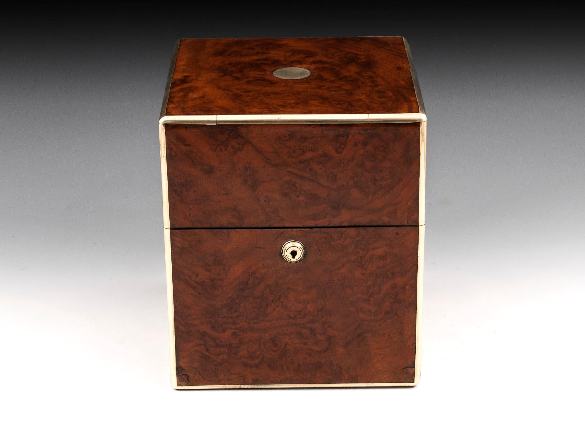 Antique jewelry box veneered in burr walnut, bound in brass edging for added strength. 

Opening this jewelry box reveals a purple velvet lined interior with two removable stacked trays with padded jewelry compartments, with brass and ribbon