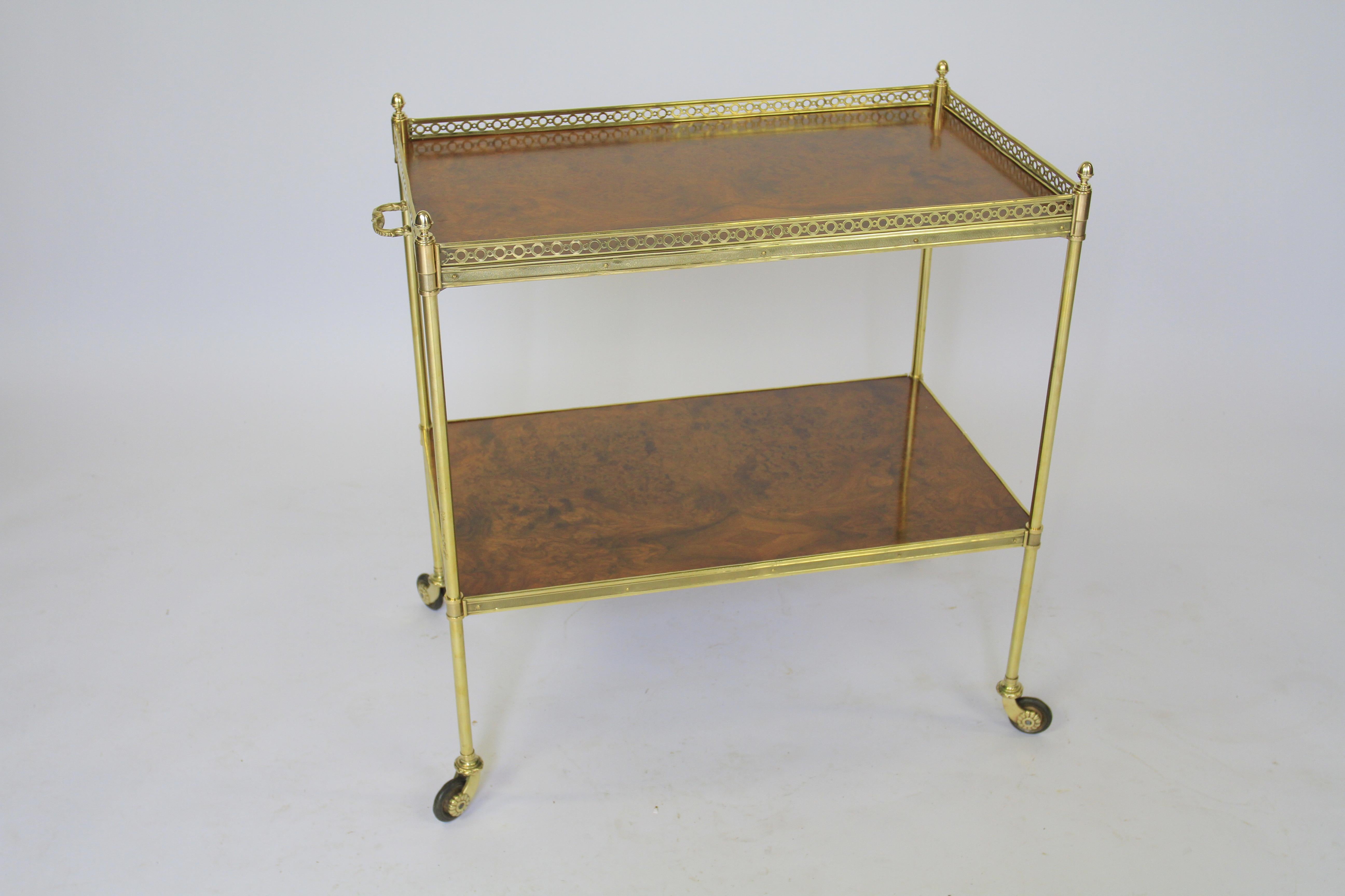Burr Walnut & Brass Serving Trolley circa 1920s
2 Tier with 2 Burr Walnut shelves
Brass Frame, brass gallery around top
pair cast  brass decorative handles each side
turned brass supports with acorn finials,
cast brass wagon castors with rubber