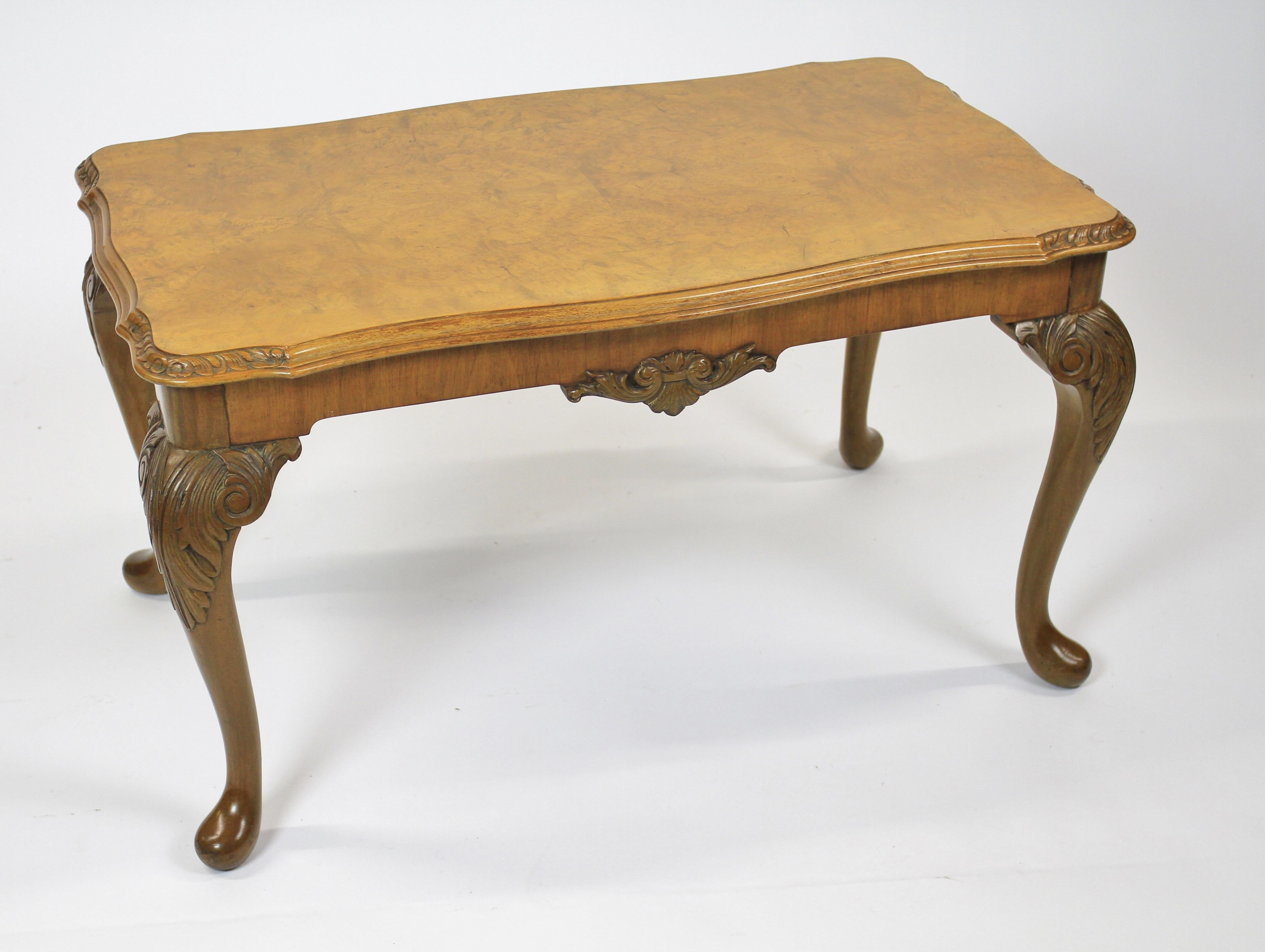 Burr Walnut & Carved Coffee Table circa 1930s
Top With Burr Walnut Veneer, 
Shaped Carved detail on 4 corners. 
Apron with carved shell & scroll detail front & back
Sitting on 4 Cabriole shaped legs with leaf caving on knees
Recently Polished