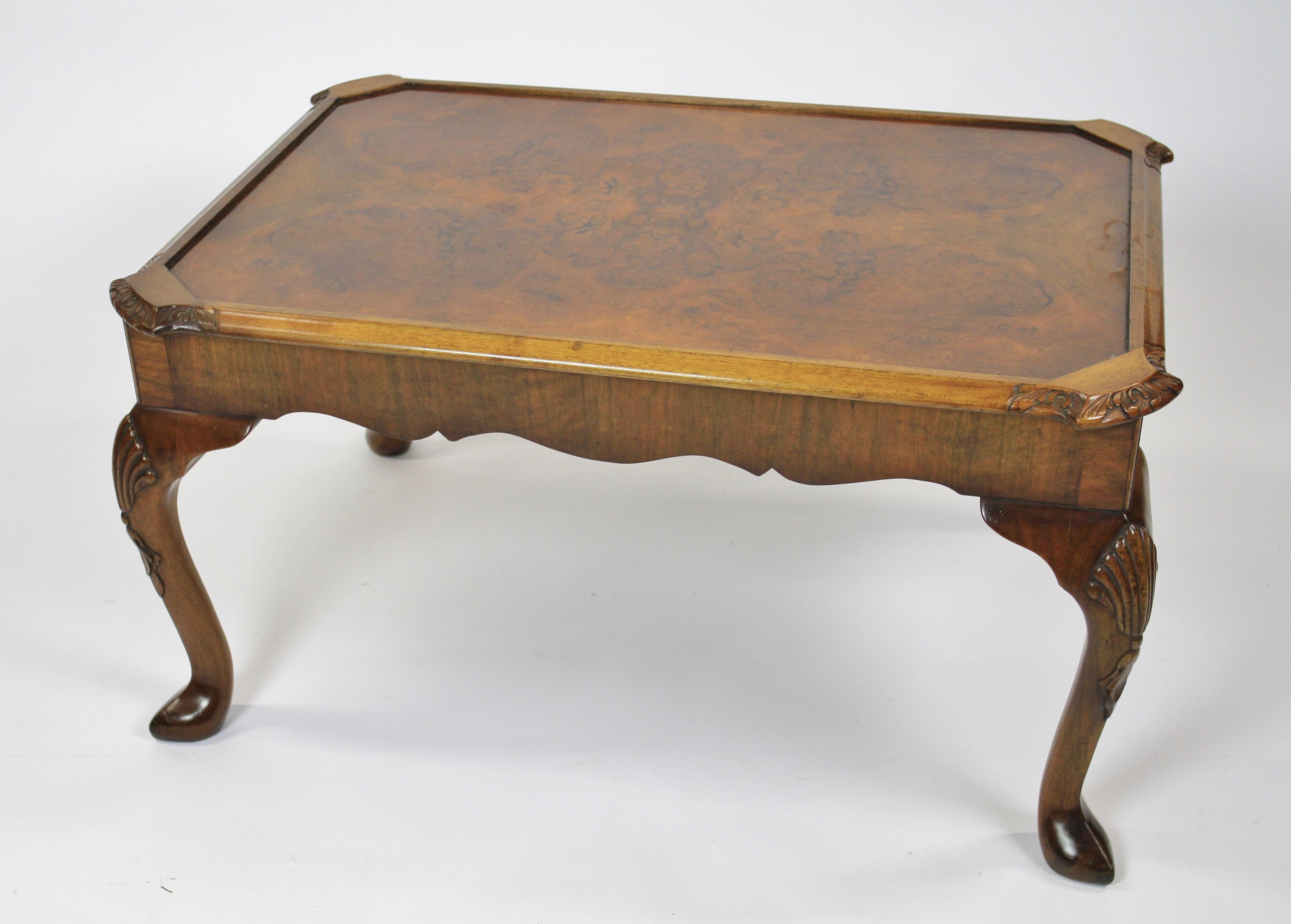 Burr Walnut & Carved Coffee table circa 1930s
Inset Top with Burr Walnut veneer, 
With: inset plate glass top, 
4 canted corners with carved detail, 
Moulded edge, 
Shaped Apron, 
Single Drawer each side, with oak-lined Drawers,
Cabriole shaped legs