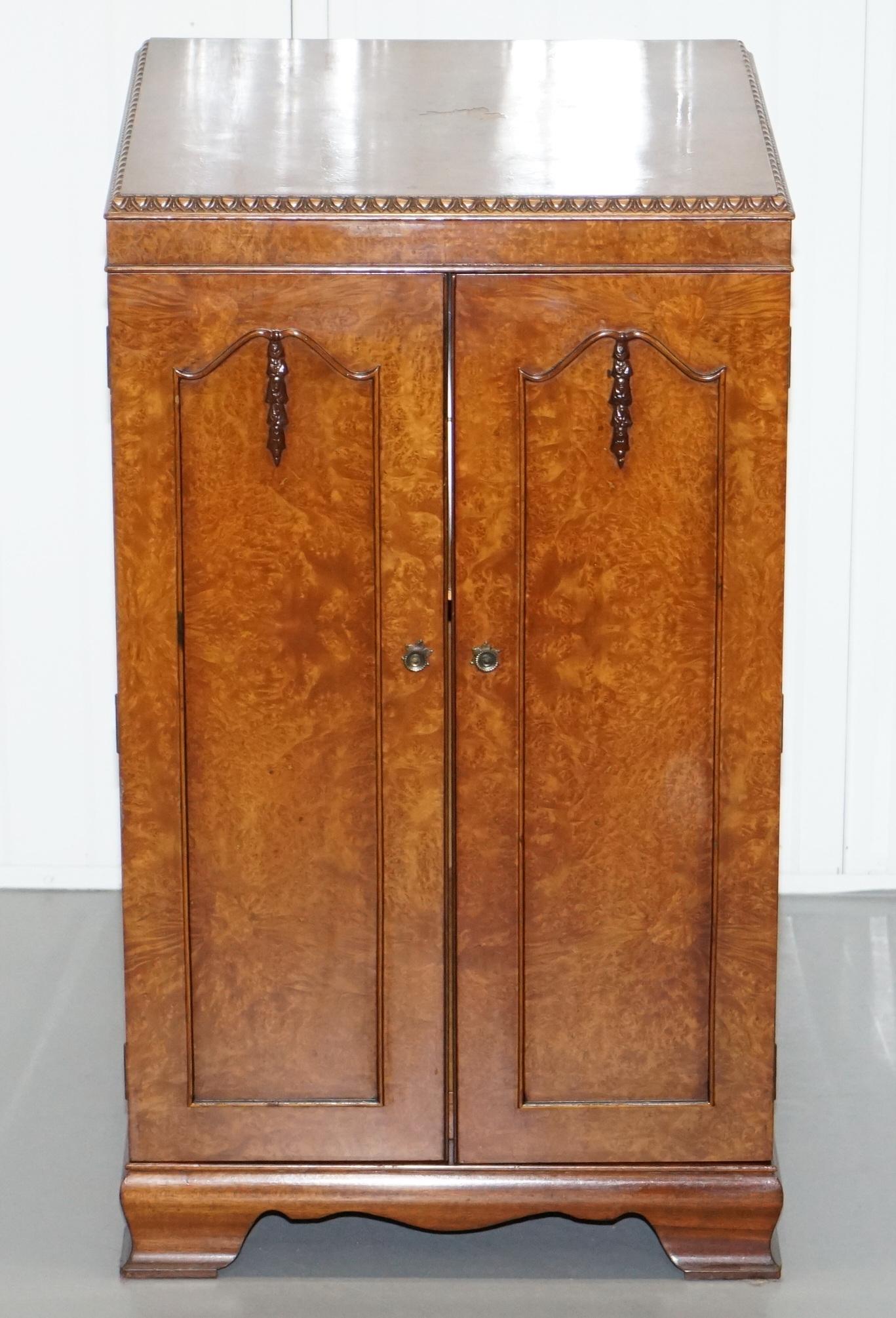 We are delighted to offer for sale this lovely circa 1920 Art Deco burr walnut drinks cabinet with mirrored back

A good looking and functional piece of furniture, the timber patina is to die for as is the detail, the edges are all hand carved,