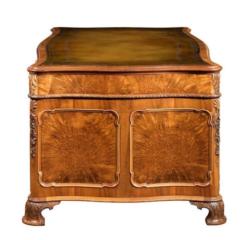 The shaped leather-inset top set above three drawers and with three further drawers on either side of the kneehole, the ends and back with shaped panels, carved with flowers, shells and acanthus leaves, stamped on the lock ‘Gillows Lancaster’.