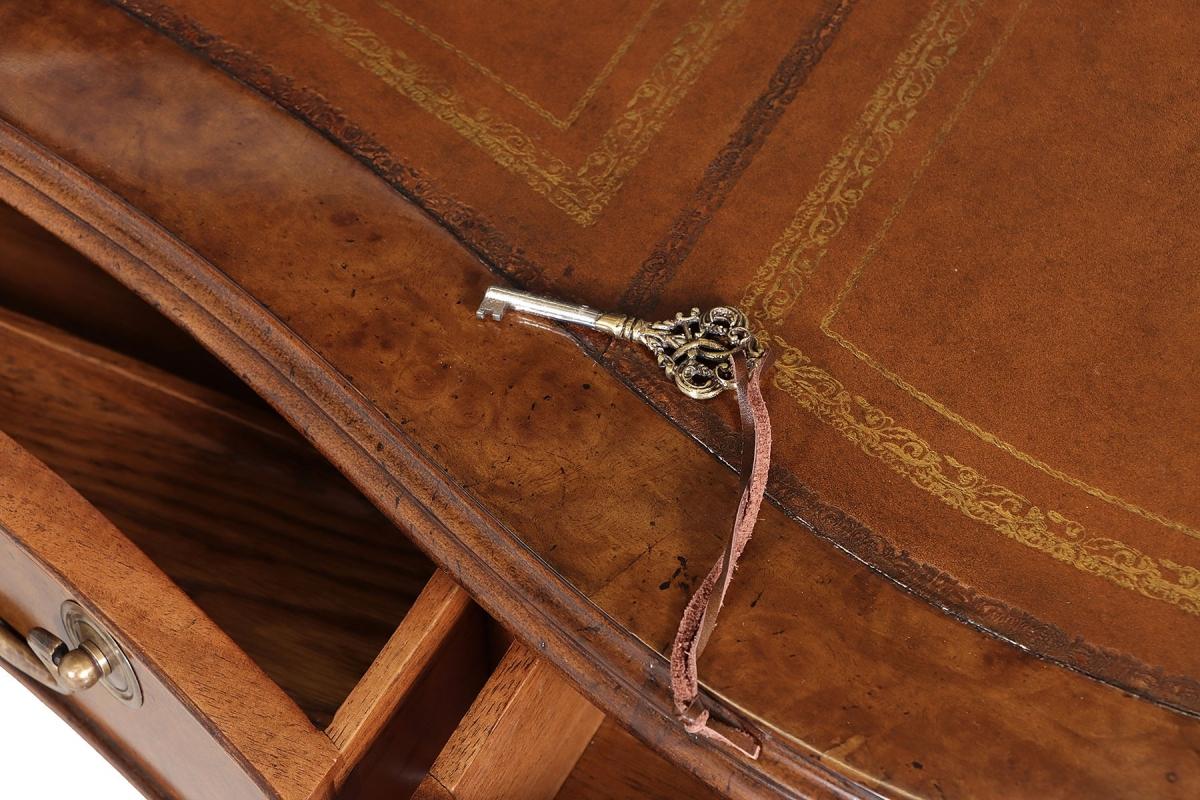 Elevate your workspace with this exquisite burr walnut kidney-shaped pedestal desk featuring a luxurious hand-tooled leather writing surface. Organize your essentials effortlessly with three frieze drawers on the seated side, three graduated drawers