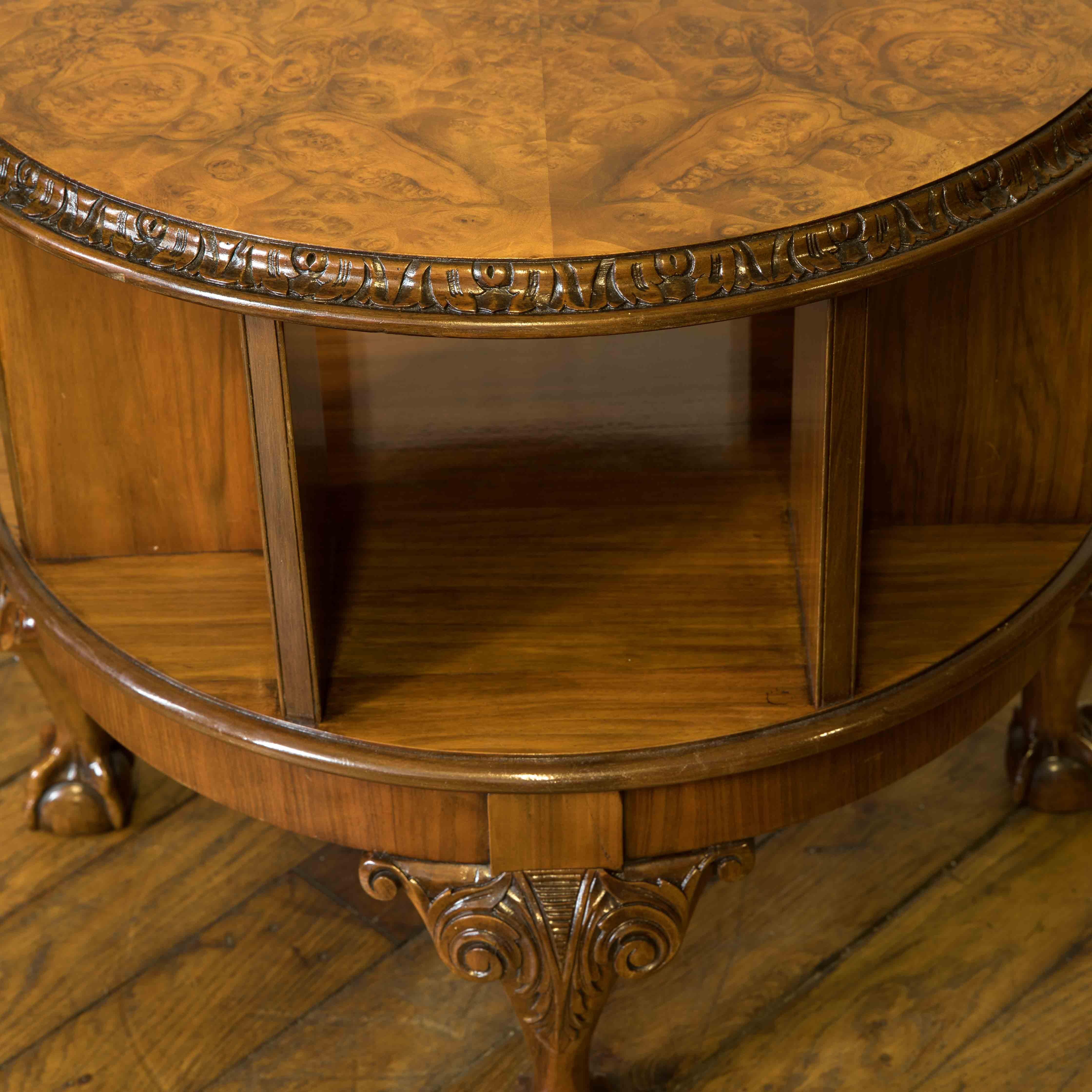 Super quality occasional table that has a revolving bookcase undercarriage. Made from walnut, with a wonderful burr walnut top, the design has a strong Chippendale influence. An unusual piece that is both utilitarian and attractive at the same