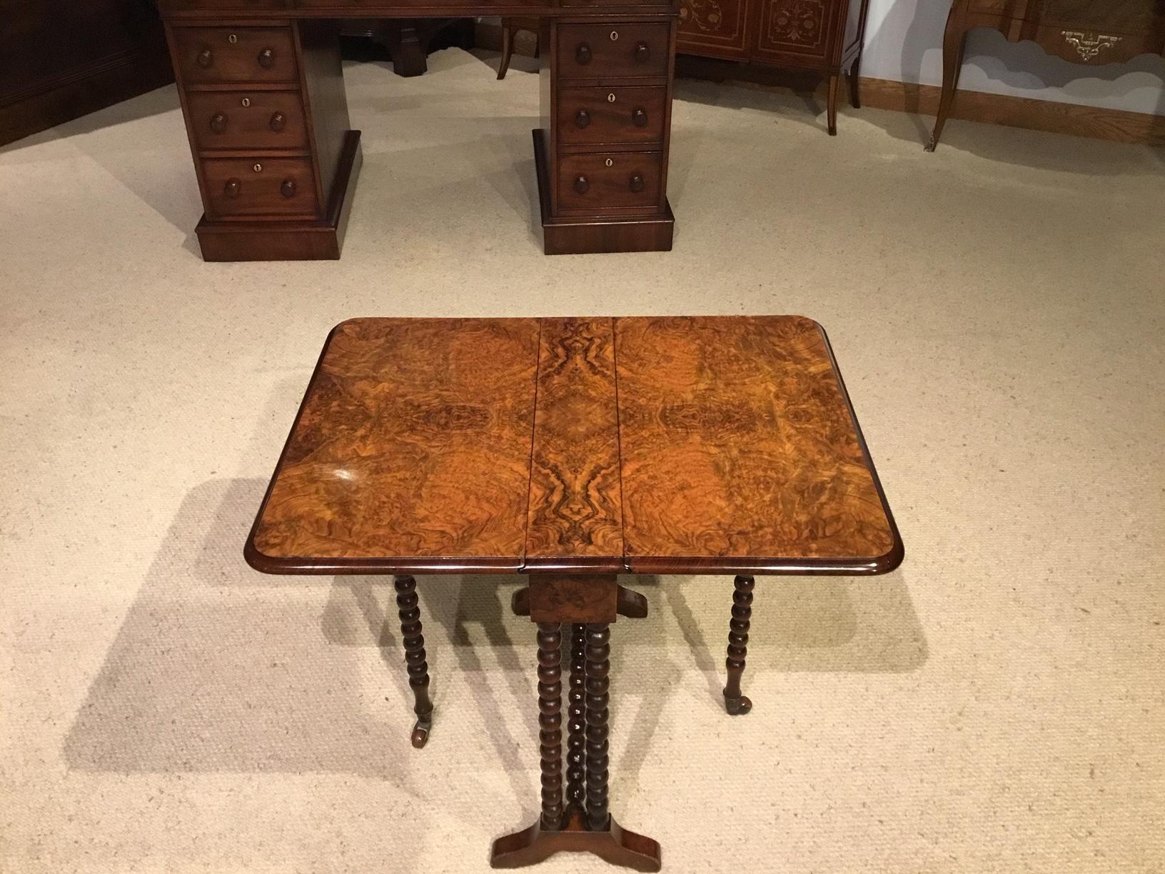 A beautiful burr walnut Victorian period baby Sutherland table. Having a rectangular hinged top with twin drop leaves veneered in book matching burr walnut veneers. Supported on bobbin turned walnut supports. England, circa 1880

Dimensions: 20