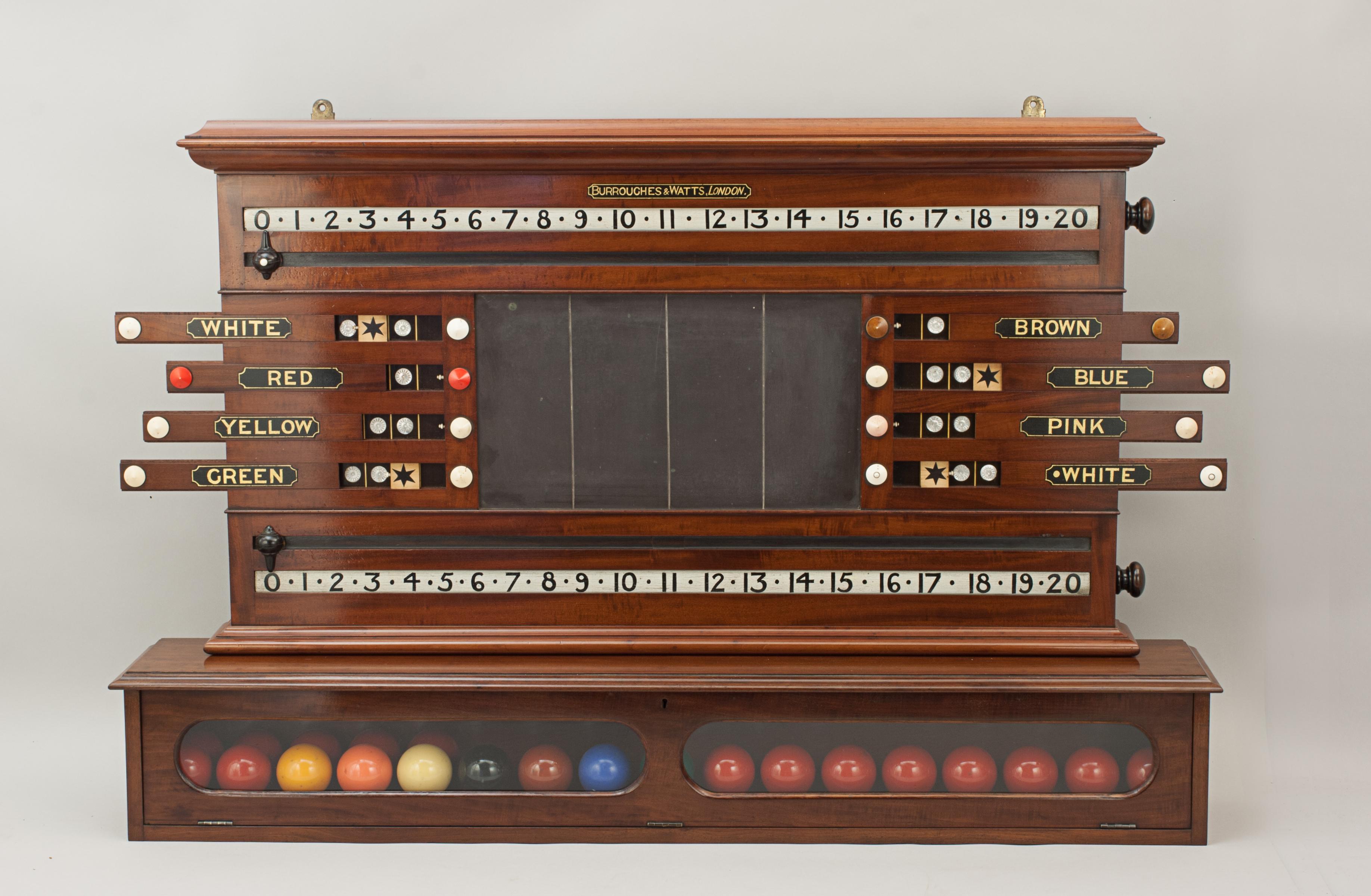 Burroughes & Watts Billiard, snooker score board, life pool, ball cabinet.
A nice combined billiards and life pool scoreboard made of mahogany by Burroughes & Watts. The billiard scorer sits upon a lockable ball cabinet that can house 34 balls. The
