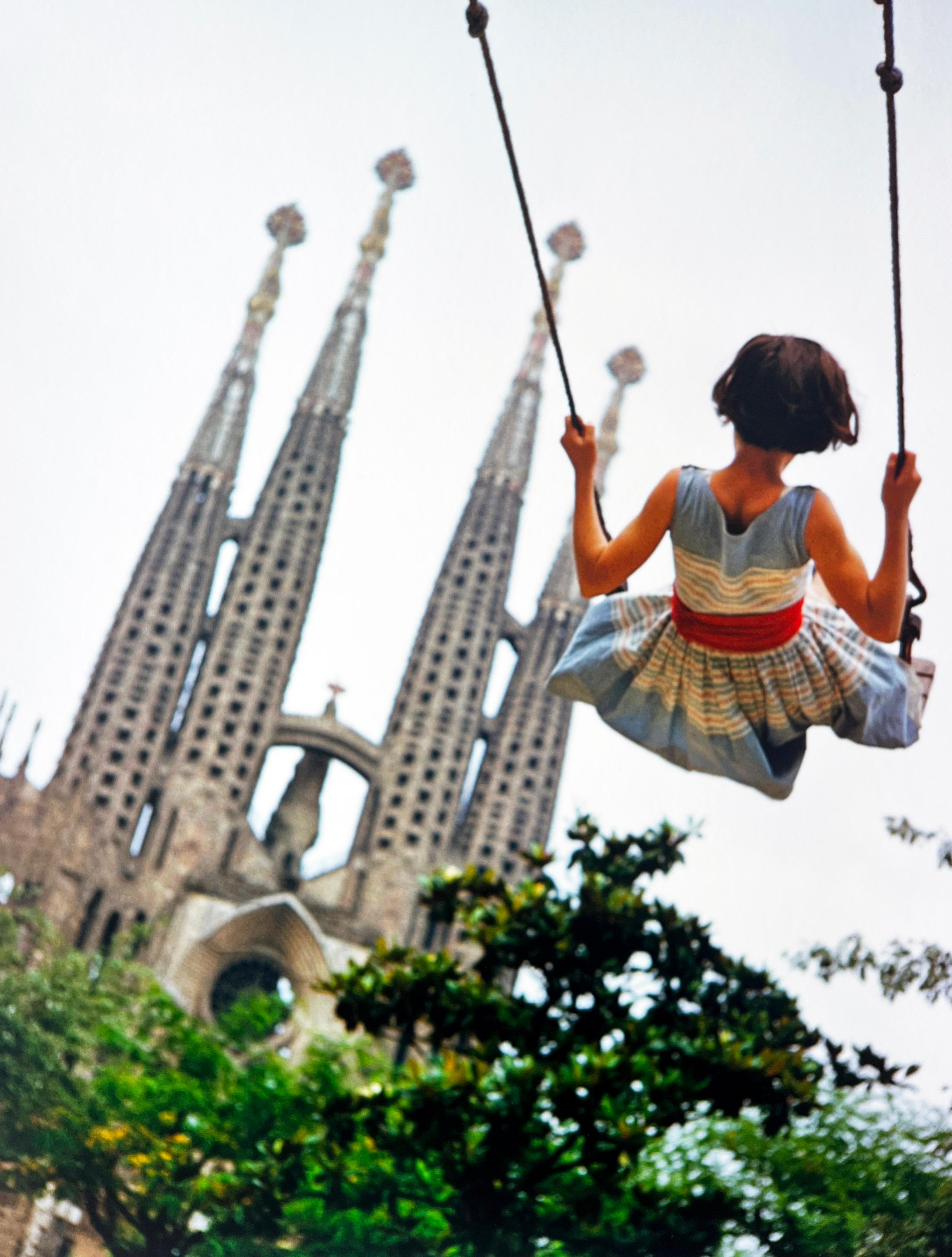Catedral de Gaudí Barcelona, España, Fotografía en color de chica joven, columpio - Portrait Photograph Gris de Burt Glinn