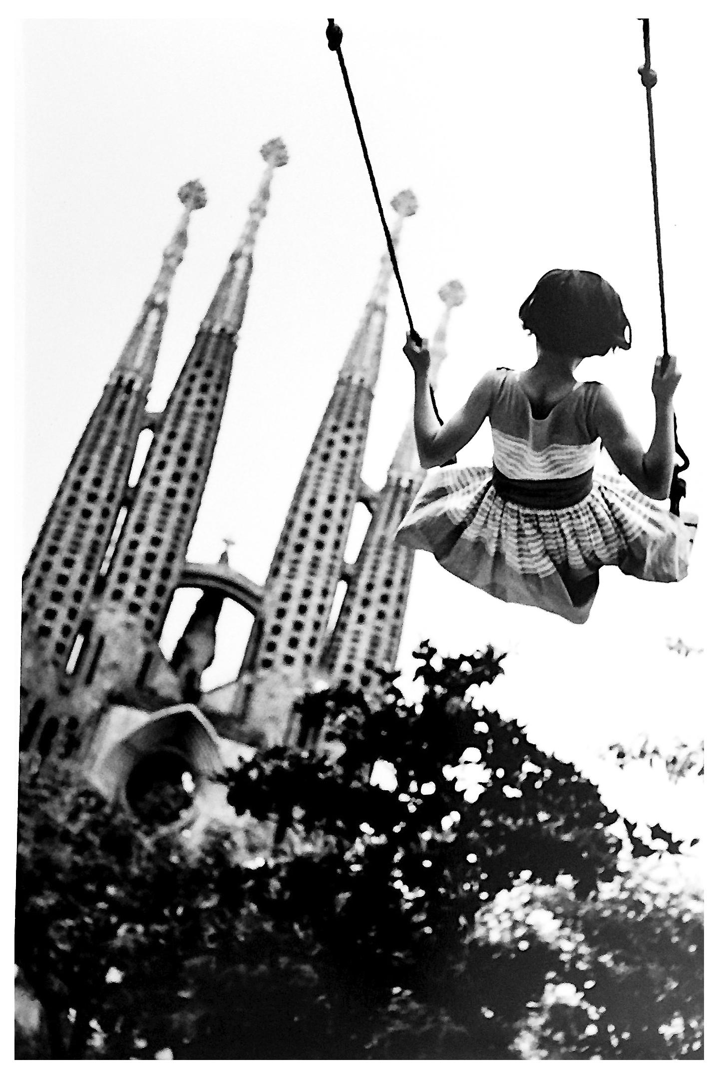 Burt Glinn Portrait Photograph - Swing, Black and White Portrait Photo of Child and Gaudi Cathedral Barcelona