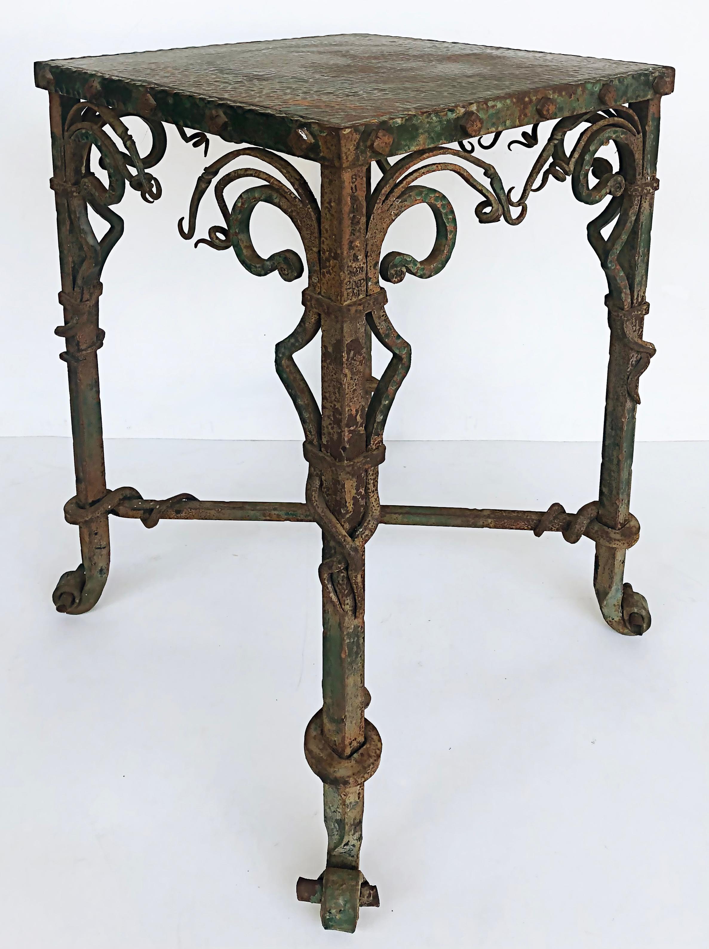 Buschere & Son wrought iron hammered copper side/table/plant stand/pedestal

Offered for sale is a Buschere & Son hand-wrought plant stand/pedestal/side table with a hammered copper top. This exquisite piece shows the intricate ironwork associated
