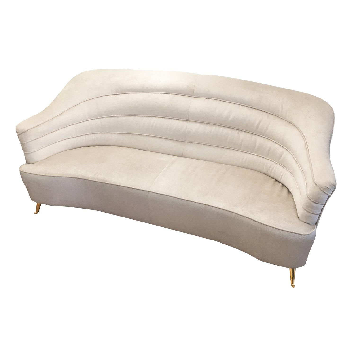 Elegant sofa designed by famous Roman Architect Busiri Vici. Has been re-upholstered in a pearl velvet. The feet are brass.

Conditions: Some wear to the fabric. Feet have been replaced. 
