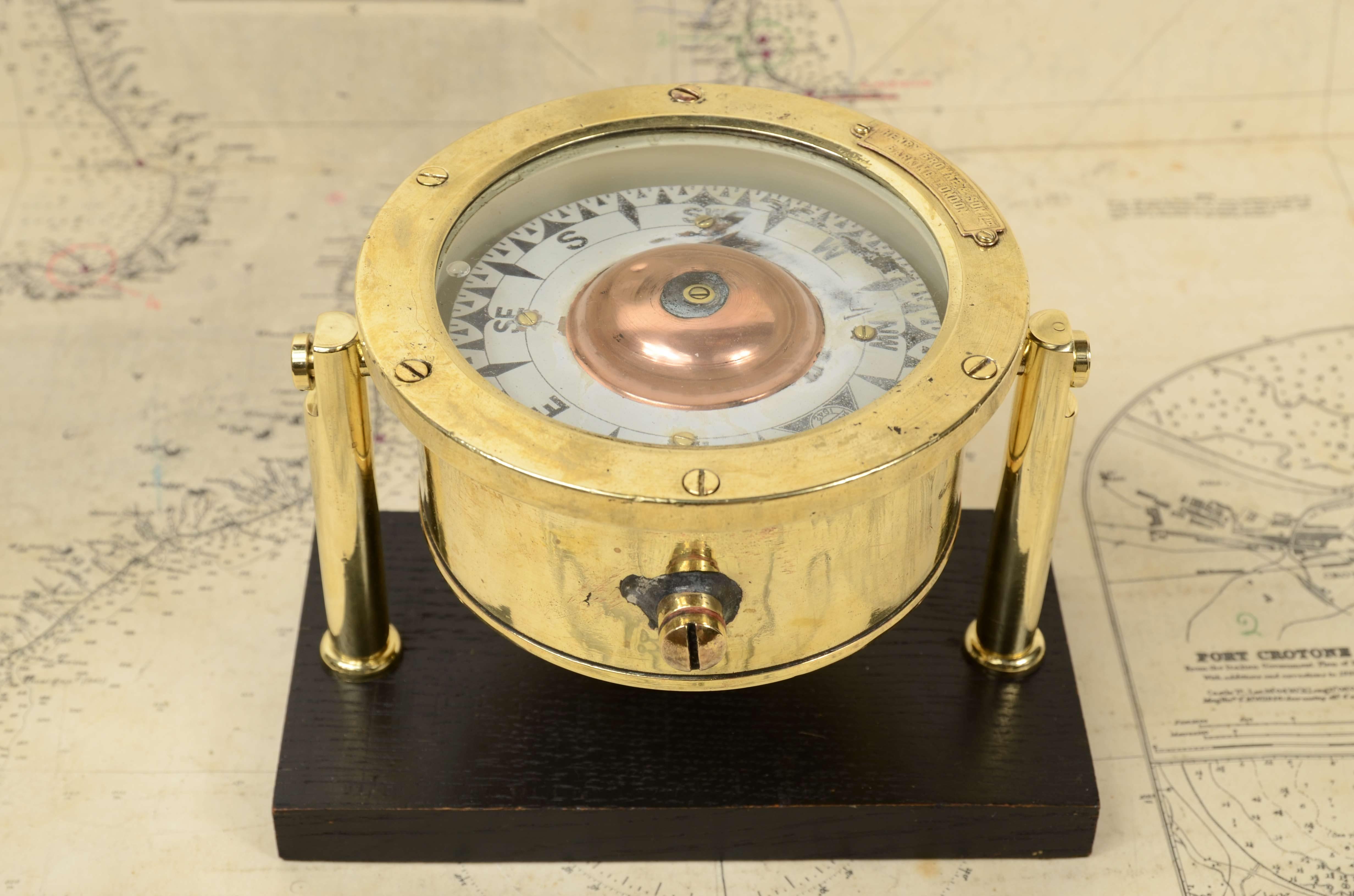 Nautical magnetic compass, signed by Henry Browne & Son Ltd   Sestrel  1942, Barking & London  1942. Good  condition, slight abrasion on compass rose. The compass is mounted on ebonized wooden board  and custom-made reelized brass. 
Compass diameter