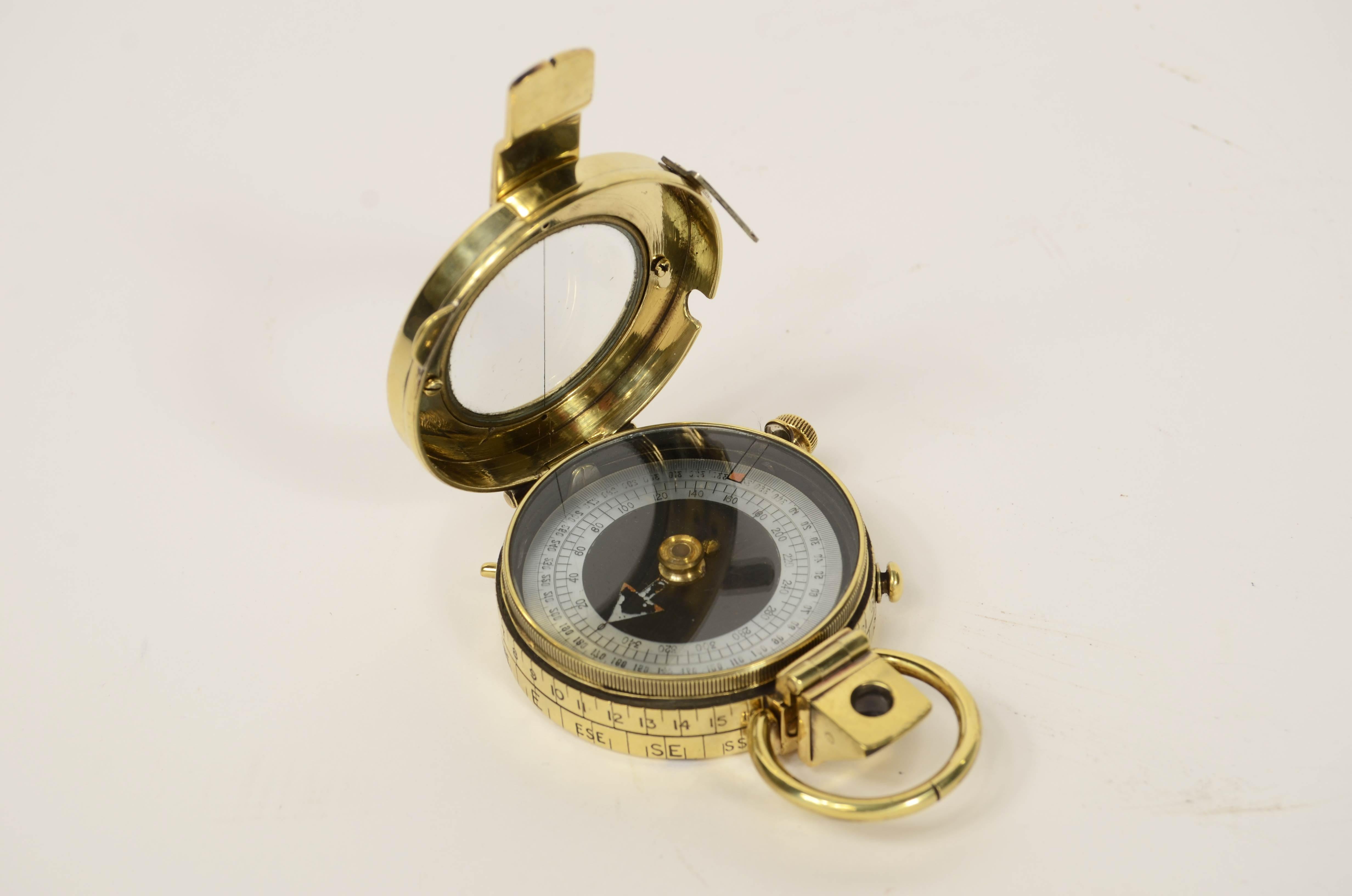 Brass prismatic surveying compass; this is a small compass, Verner's Pattern named after the designer, Colonel William Willoughby Cole Verner  (1852-1922) and produced in 1917 and supplied to British officers, typically used in navigation. It can