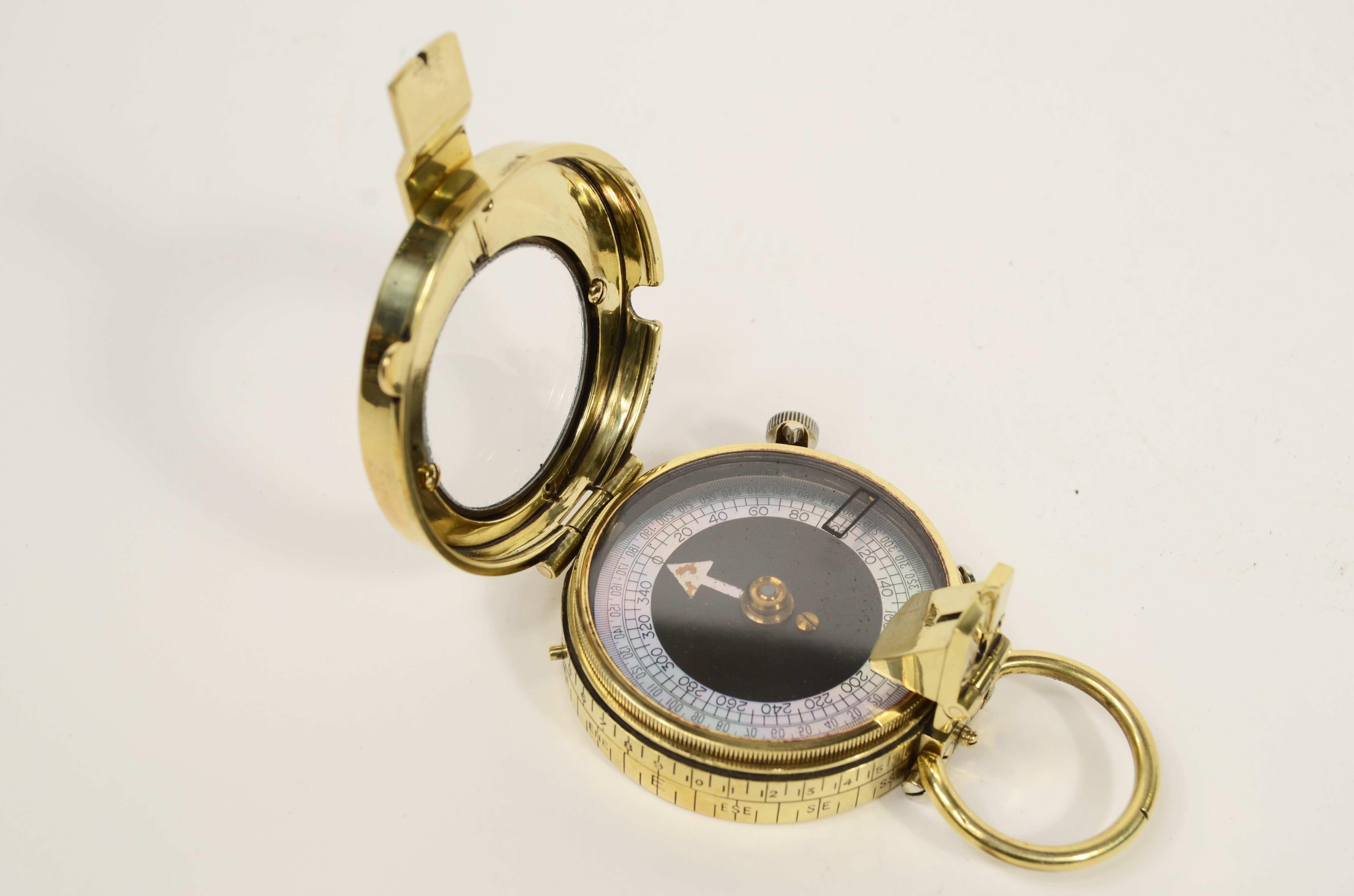 Brass prismatic surveying compass; this is a small compass, signed E. Koehn Geneve Suisse No. 58611, Verner's Pattern VII after the name of the designer, Colonel William Willoughby Cole Verner  (1852-1922), produced in 1917 and supplied to British
