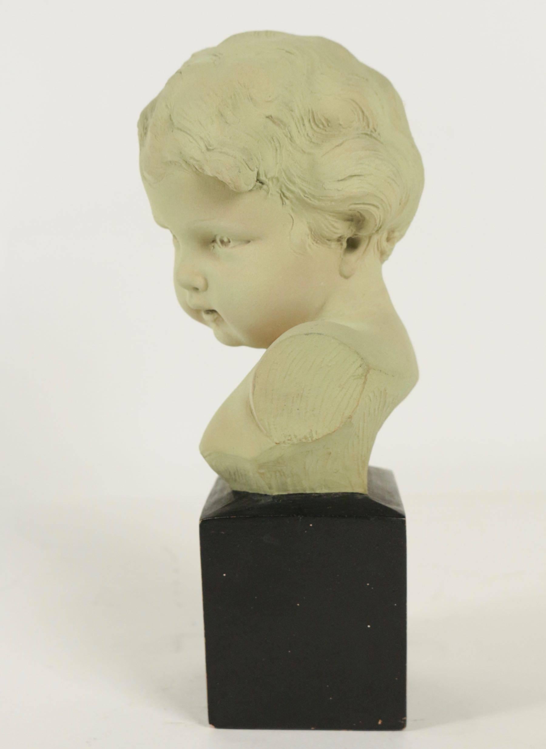 statue of a young boy with windswept hair