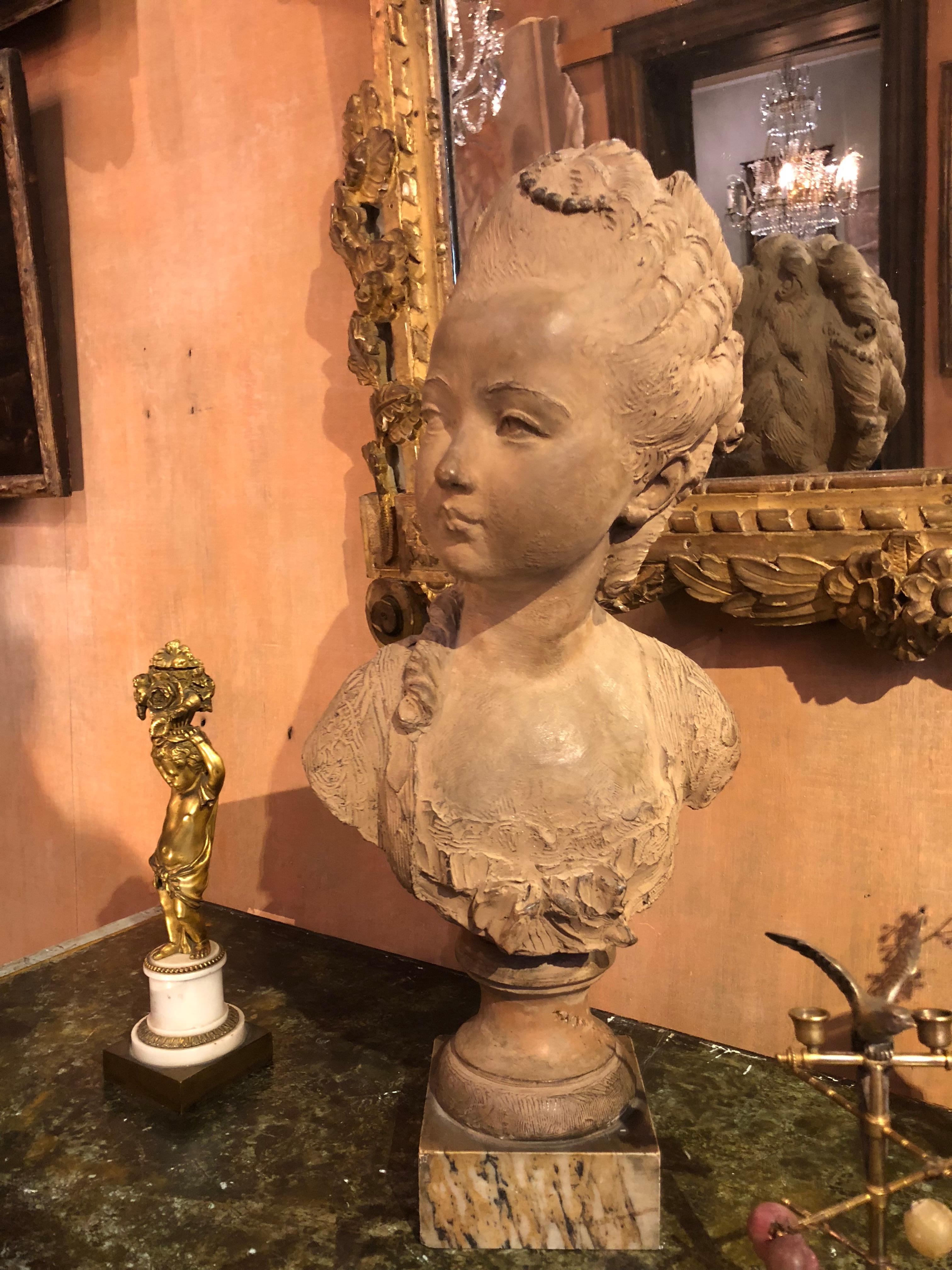 Terracotta bust of a little girl by Fernand Cian (1889-1954) on a marble stand, in the taste of the 18th century portraits. She looks at her pendant, the little boy...
Beginning of the 20th century.

Fernando Ciancianaini signs under 