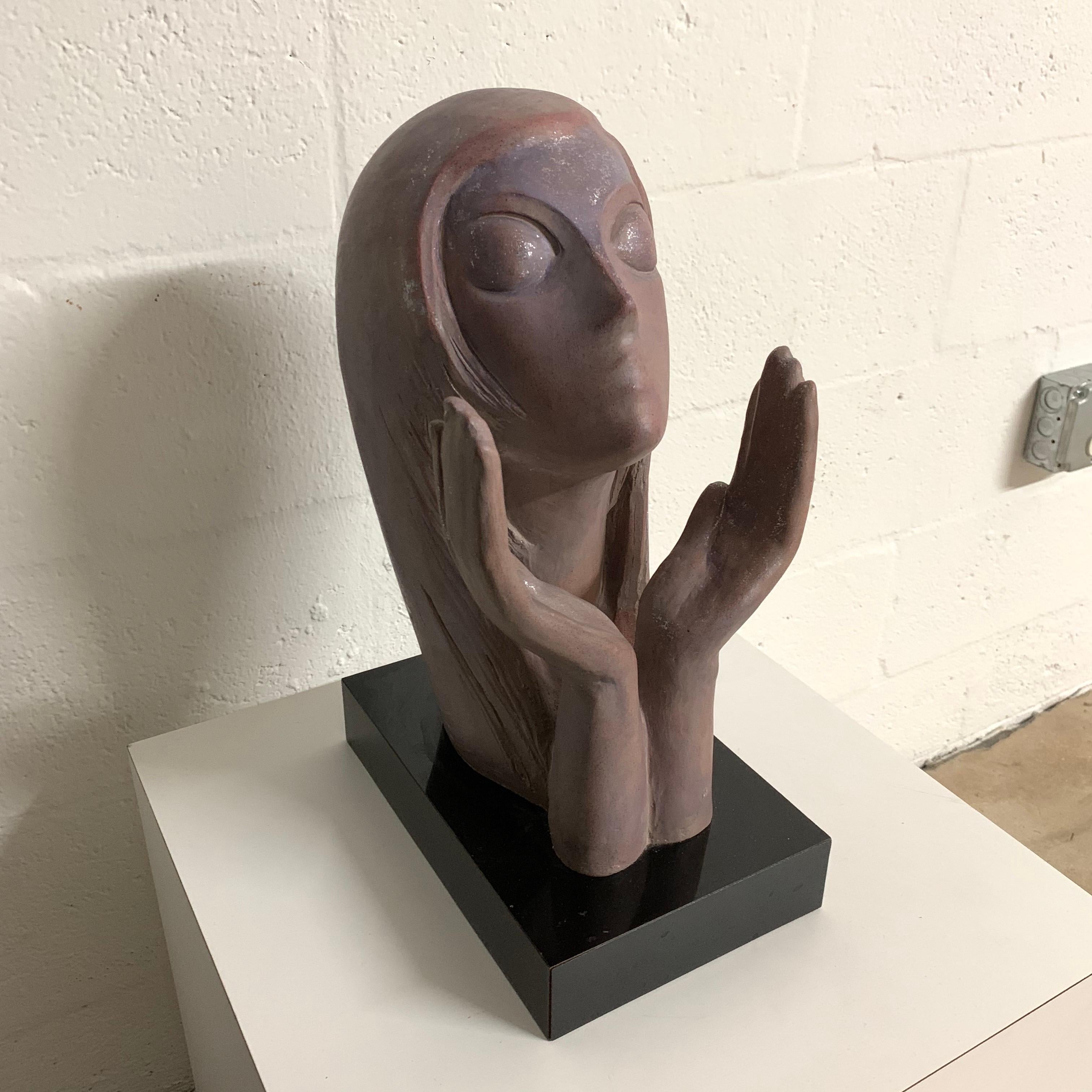 Bust of woman with open hands lifted rendered in lavender and violet painted plaster composite with a silver sparkle glaze on a black mica base, signed Austin Prod, 1981.