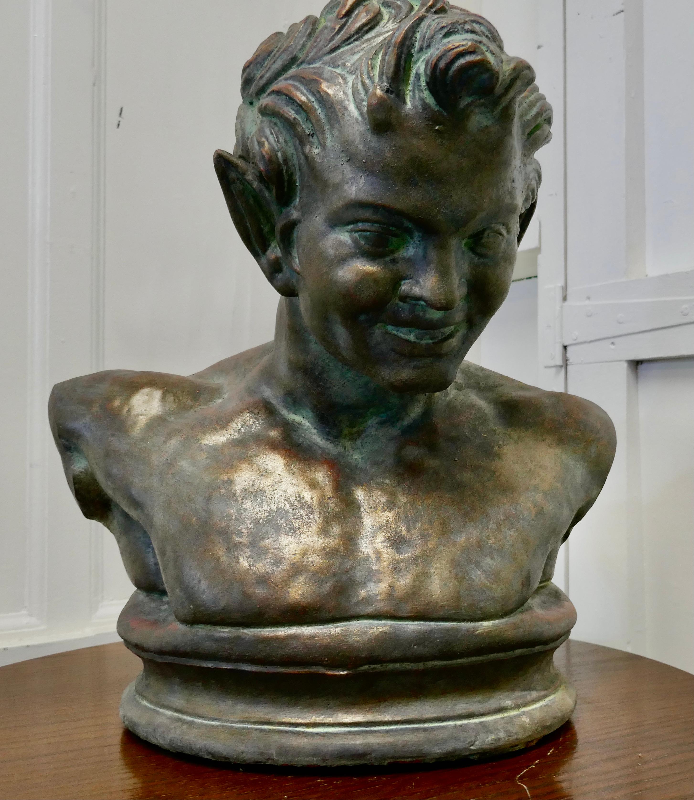 Bust of a young satyr in a bronze patina

This is a very heavy cast plaster piece, it has a very attractive aged bronze patina and shows a young satyr
The satyr has an impudent expression on his face no doubt as he gets older he will have a more