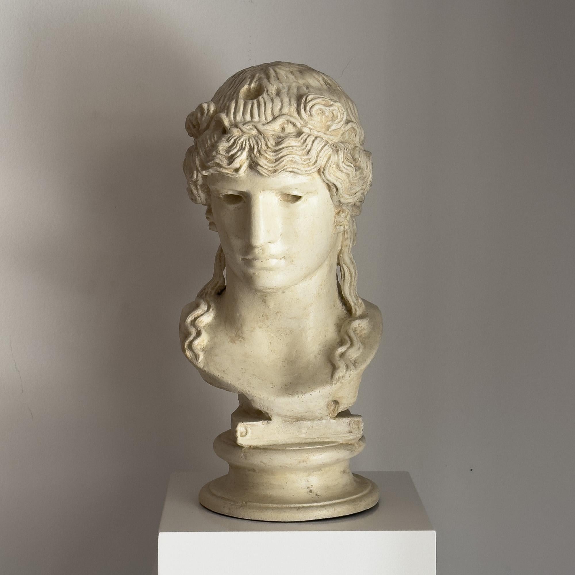 Bust of Antinoos made of moulded and carved limestone, following models of classical Rome.

It is solid stone. It is part of a series of 8 copies distributed exclusively by our gallery.