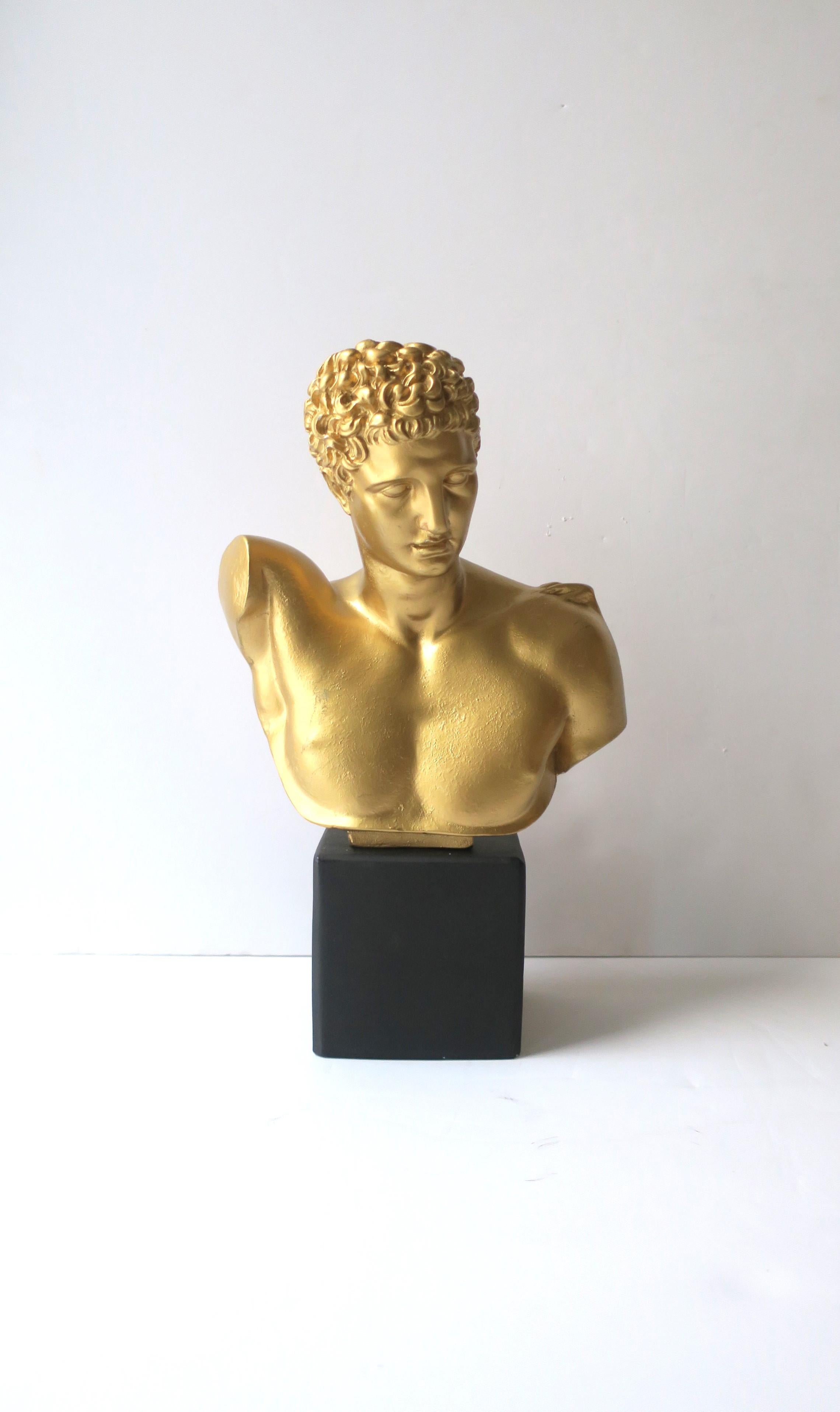 A plaster bust of ancient Greek god, Hermes. Piece is plaster with a gold overlay on bust and a matte black overlay on base. A great decorative depicting the original ancient sculpture. Dimensions: 5