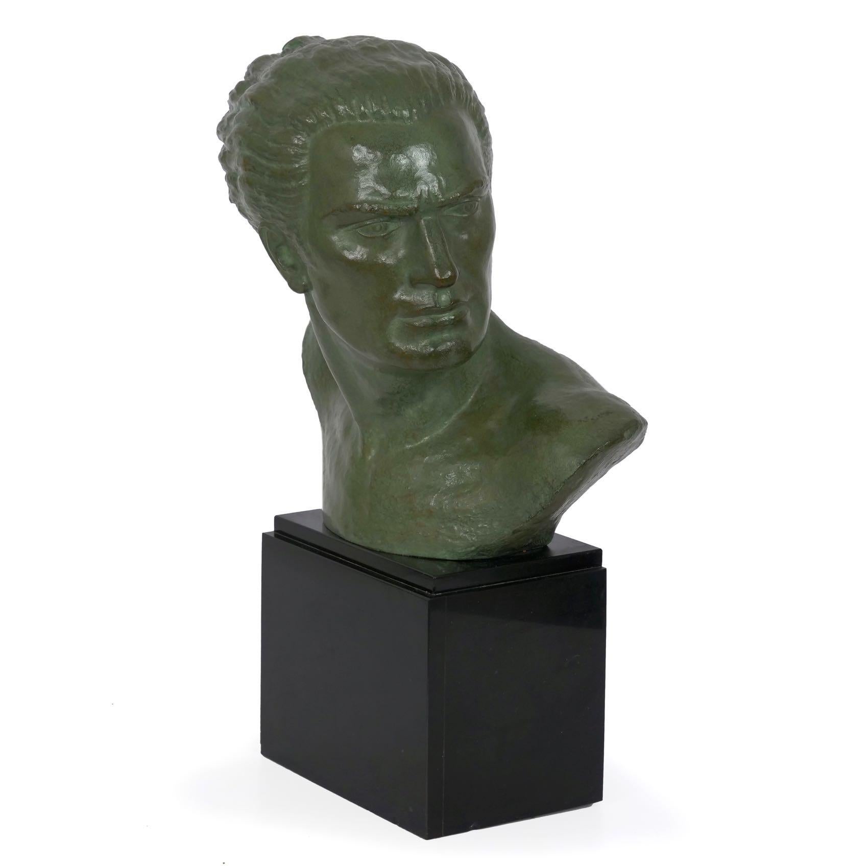 A powerful bust in honor of courageous Aéropostal aviator Jean Mermoz (French, 1901-1936), this moving sculpture was executed in bronze with a cold-painted verde surface patination by Lucien Gibert, circa 1930s.

Born in 1904, Lucien Gibert