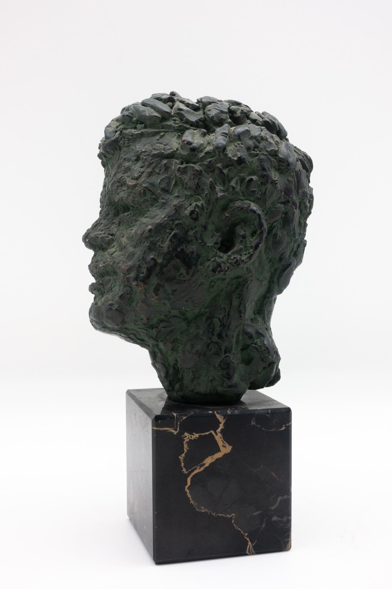 Bust of former President John Fitzgerald Kennedy made of bronze-patinated plaster on a marble base by Robert Berks, American sculptor (1922-2011).
This is an edition of one of the artist's most important works; the larger original version can be