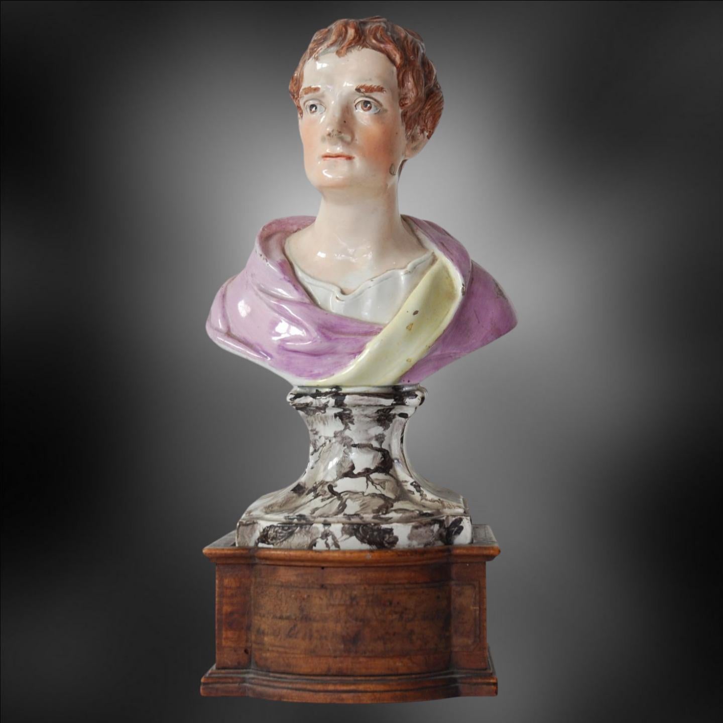 A pearlware bust of Sir Isaac Newton, by Enoch Wood. The oak pedestal adds dignity to an attractive rendering of this great man of science. A handwritten label is attached, but is unreadable, apart from the word 