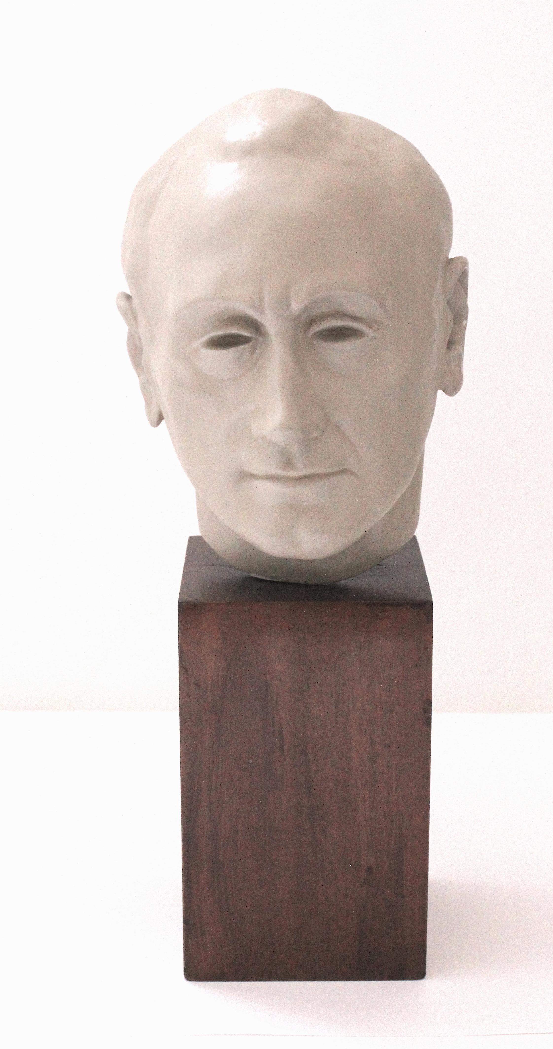This iconic bust of the famed architect Morris Lapidus will be the perfect piece for a mid-century modernest collection. 

Note: The piece is fabricated in glazed ceramic on a walnut wood base. 

Note: Overall dimensions are 14.13