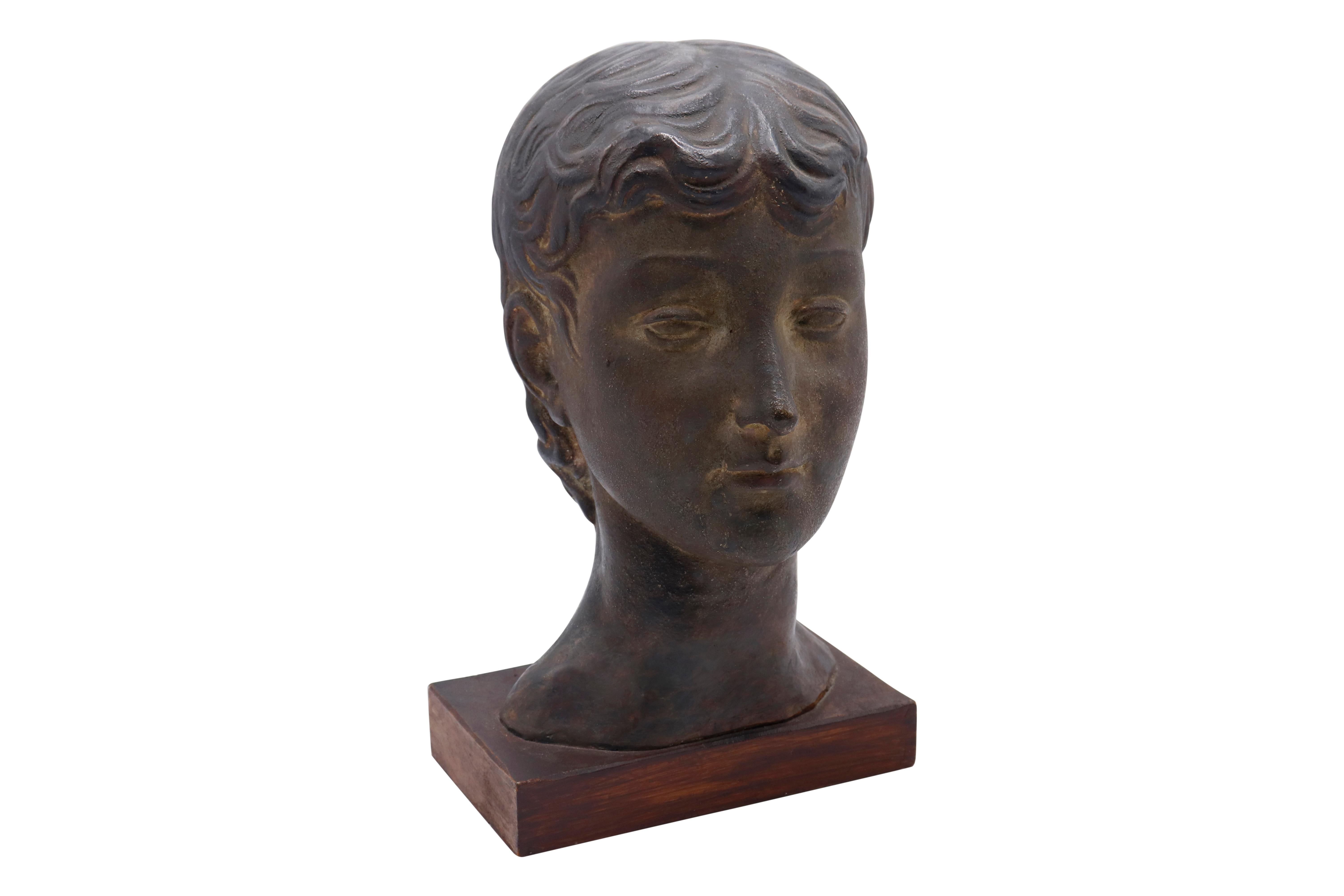 Lovely bust of young women from the 1930s subtle detail in coloring. Mounted on wooden base (a Grecian quality to her hair style).