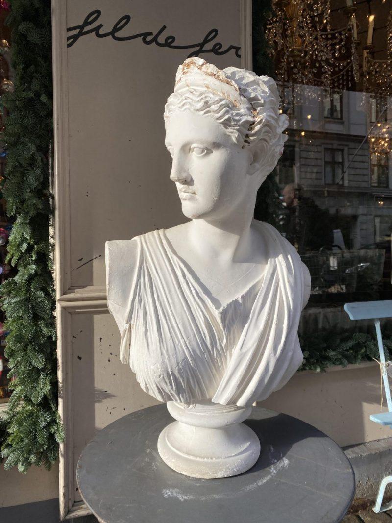 Stunning and large bust depicting the Roman huntress goddess Diana, also moon goddess. This elegant piece is formed in plaster and has wonderful genuine patina.

Originates from the South of France, and has several charming details and artistic