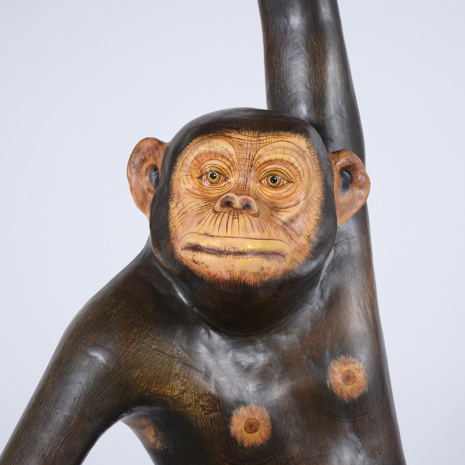 A signed Sergio Bustamante Hanging Chimpanzee sculpture hand-crafted out of paper-mache, this life-sized piece is signed 39 out of 100. This sculpture features great details a beautiful patina. The monkey comes with a trapeze from which it hangs and