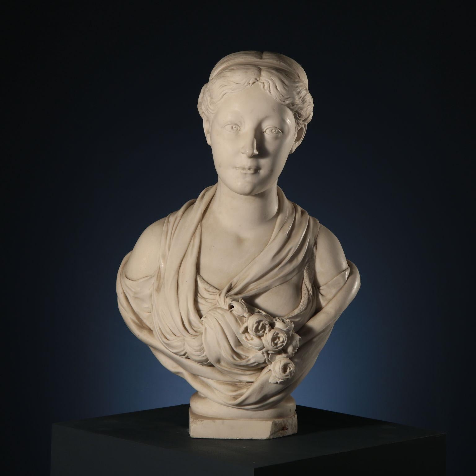 Female bust of maiden with bouquet of roses ( Spring). The maiden is portrayed with a slight smile and a deep, attentive gaze, combed with a low chignon and hair lightly held back by a sash ( according to the fashion of the early 20th century).
The