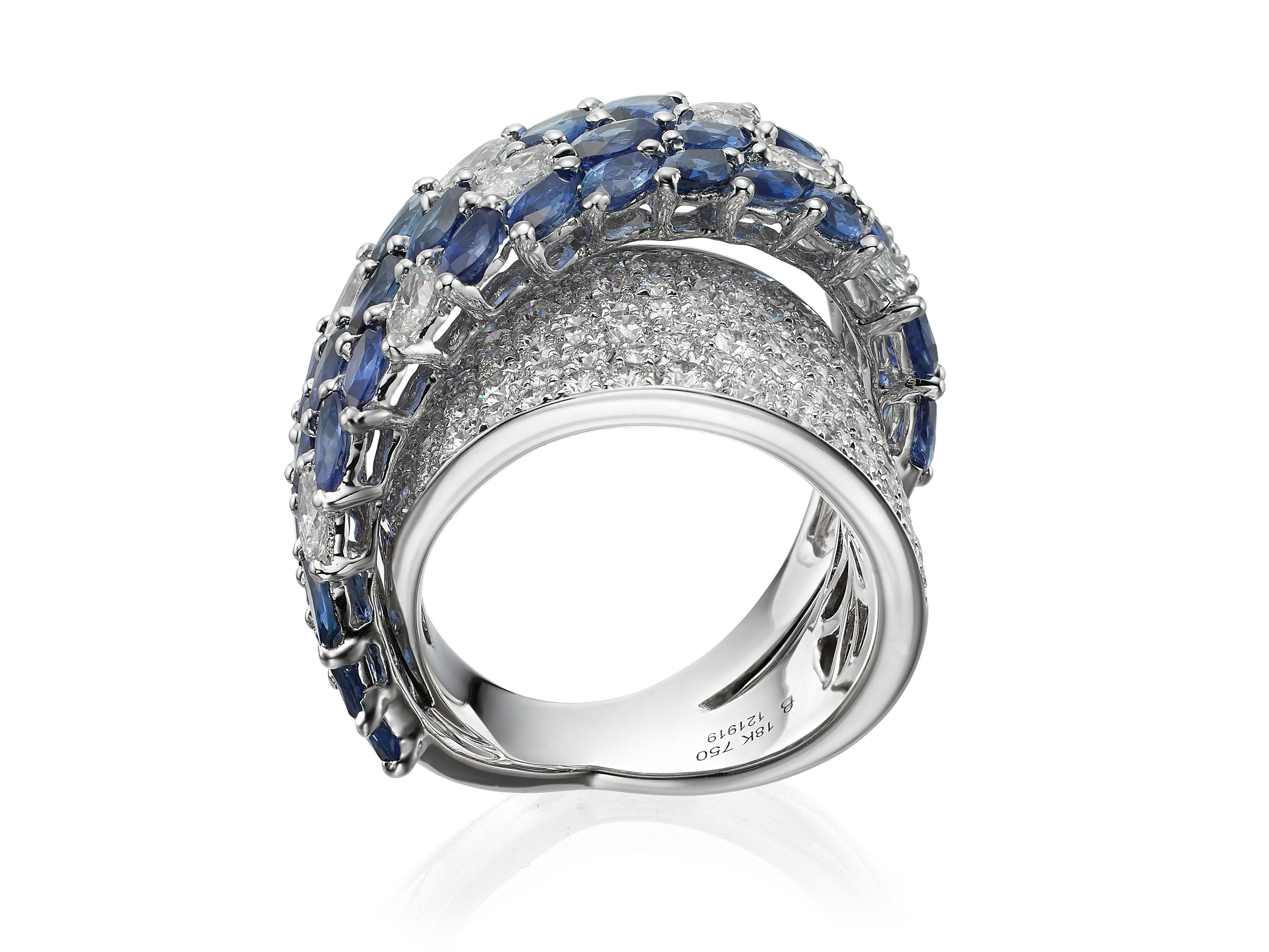 Exquisite elegance.  Royal blue sapphires contrast with the stunning brilliance of diamonds in this crossover cocktail ring.  Hand-crafted in 18K white gold, the ring features 3.06 carats of round and marquise shape diamonds  and 5.96 carats of