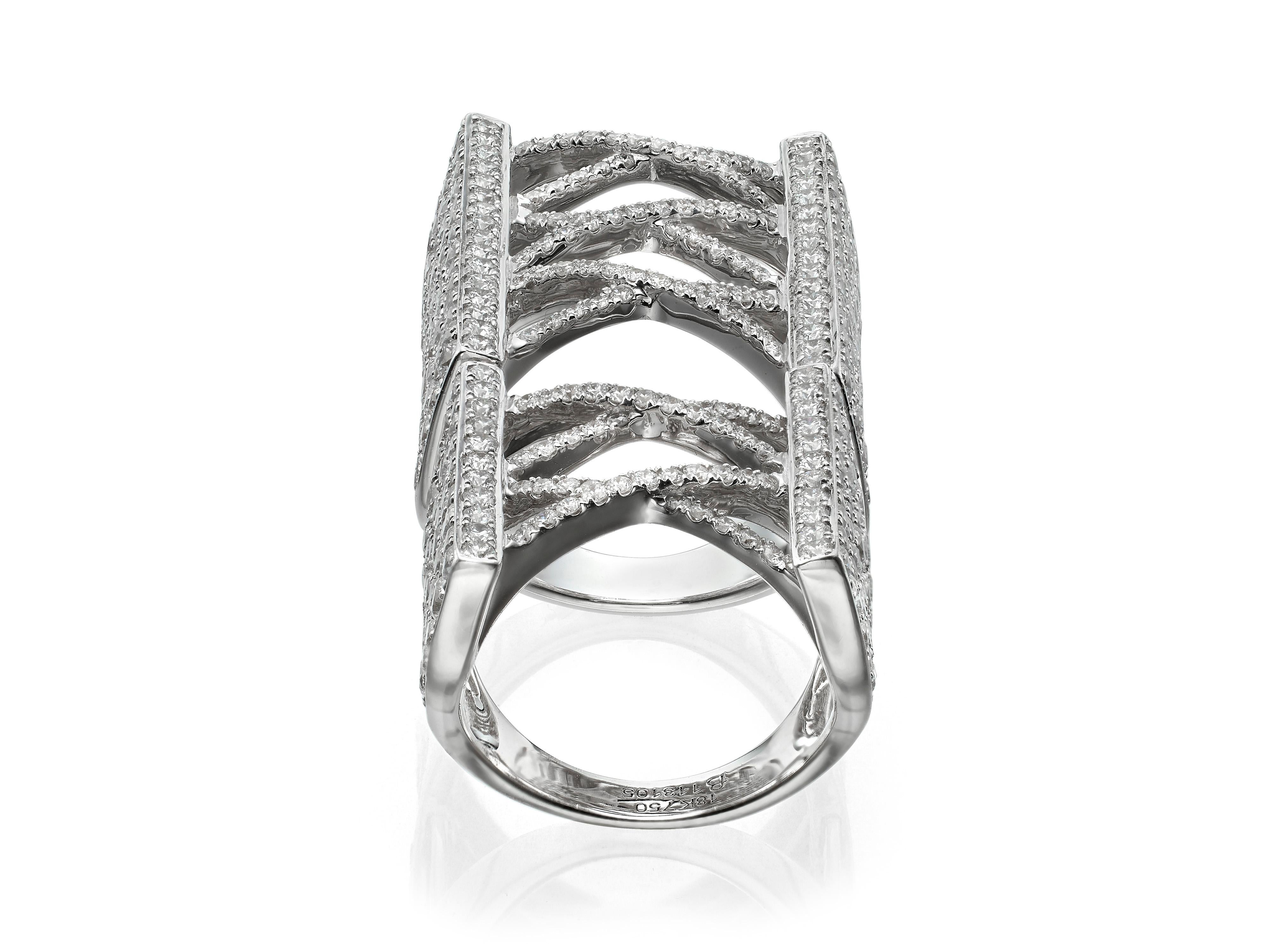 Set with 440 round brilliant cut diamonds totaling 6.72 carats, this sensational full finger corset ring features two hinges crafted to fit and move comfortably.  Set in 18K white gold.  
Currently a ring size US 7.  For other sizes, please contact