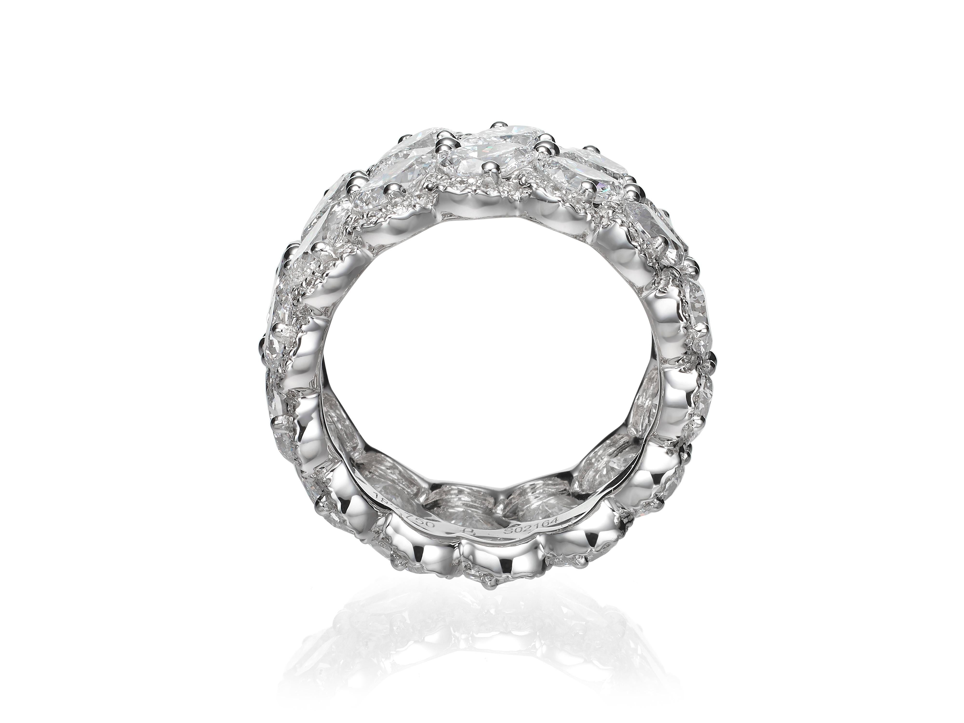 Perfect for an alternative engagement ring or anniversary present, this stunning diamond eternity band ring features two rows of pear-shape diamonds encircled by brilliant pavé-set diamond halos.  Set in 18K white gold.  
Currently a ring size US