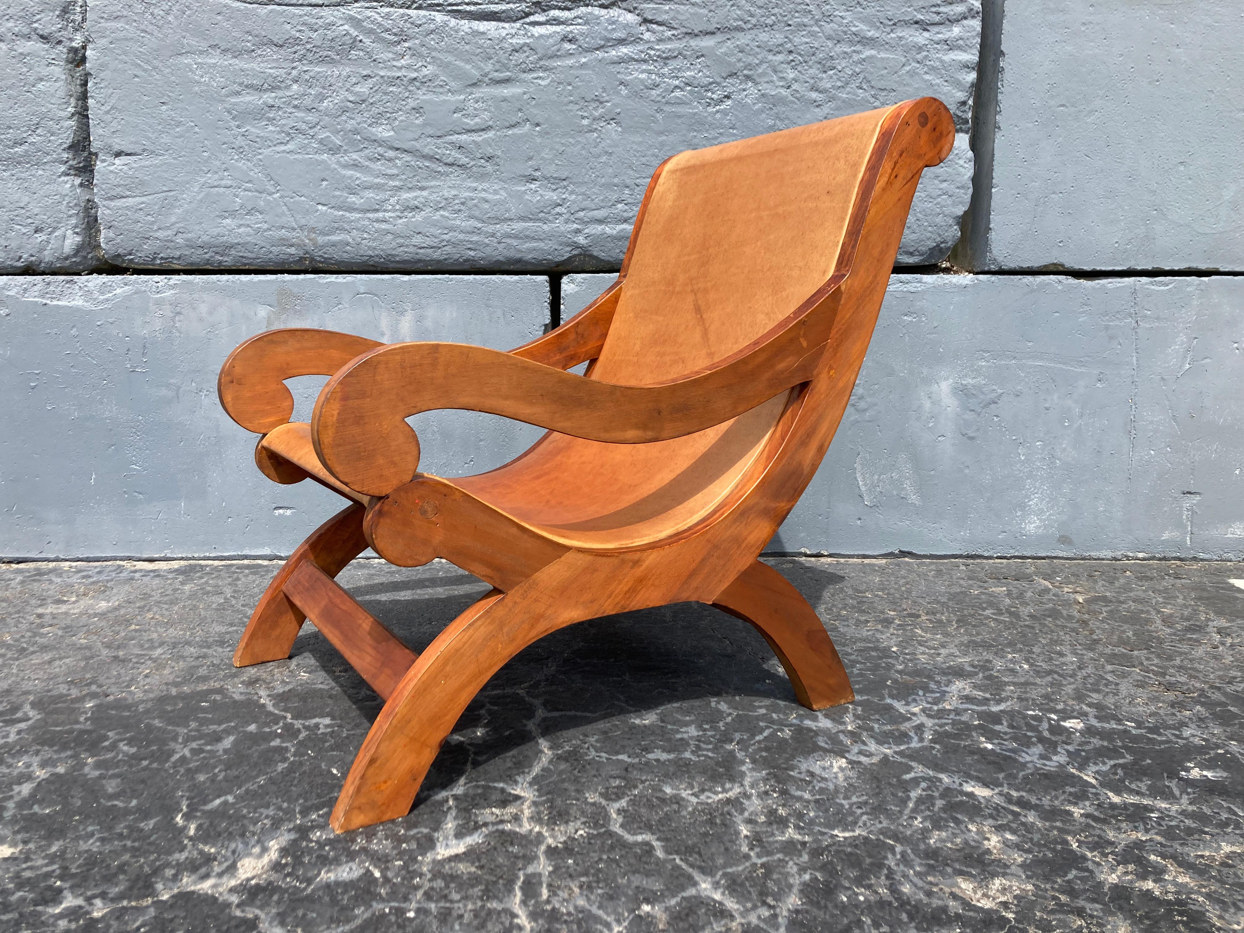Wood and leather lounge chair in the style of Clara Porset.
