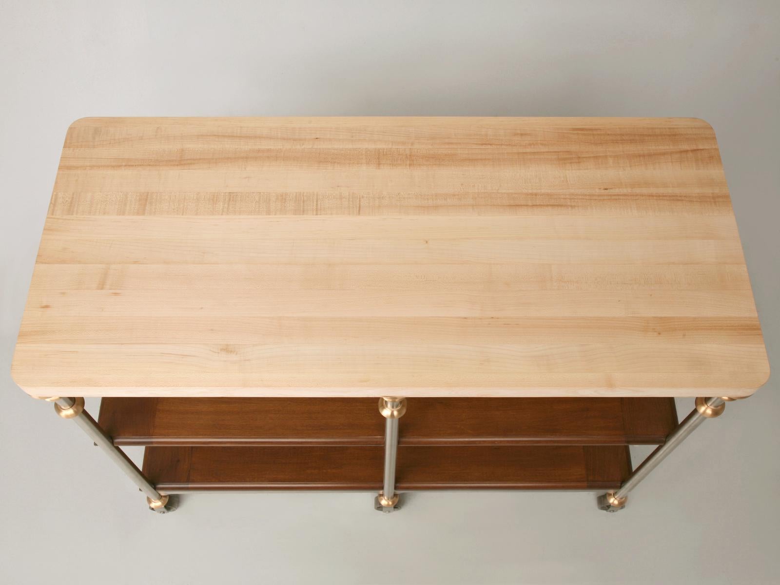 Custom made in any dimension, stainless steel and bronze kitchen island or work table, with rift-cut white oak shelves (walnut optional), breadboard ends and a butcher block top made in our on-site Old Plank workshop. This island can be reproduced