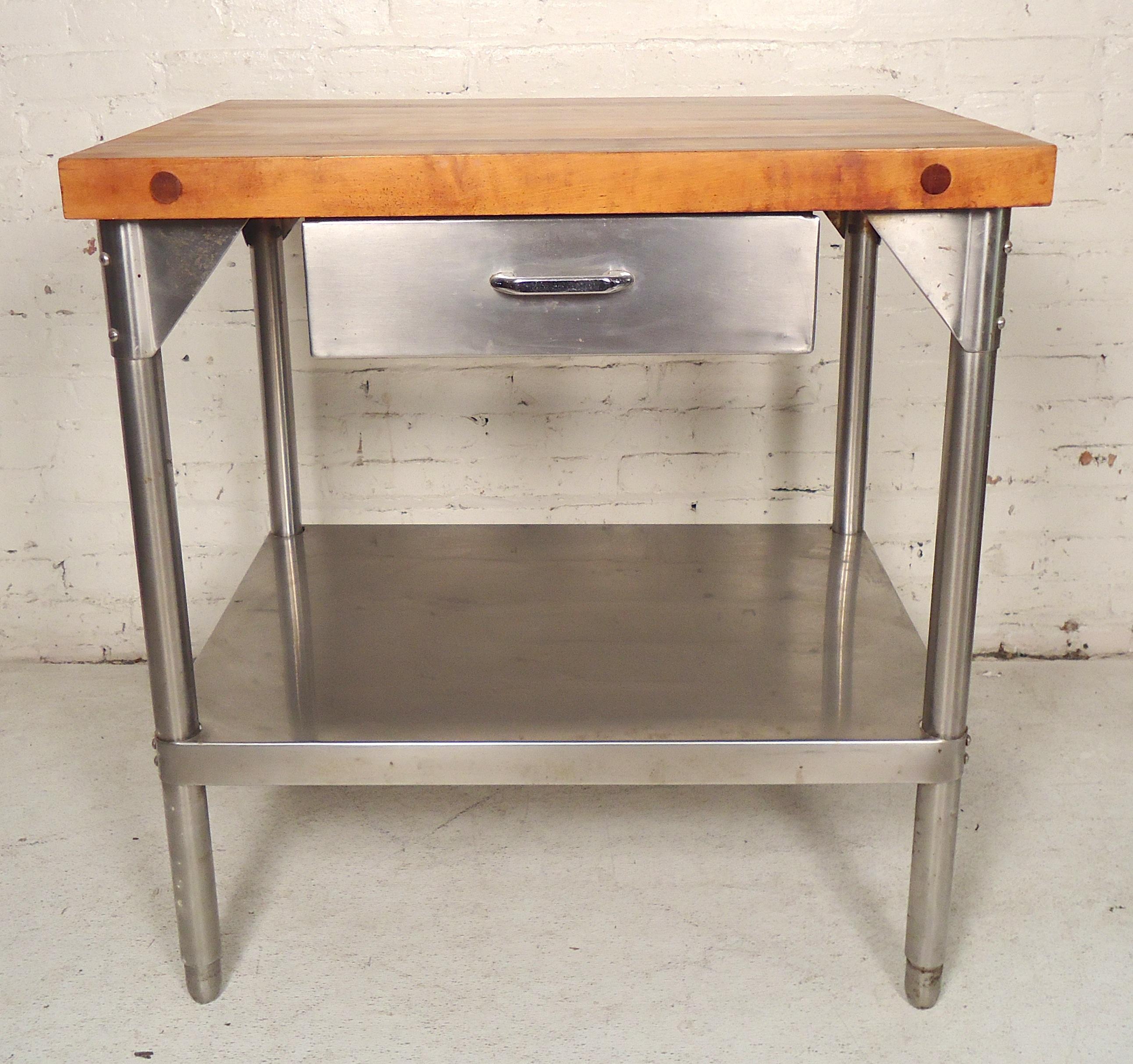 Stainless steel table with shelf and drawer storage with a thick wood top for cutting.

(Please confirm item location - NY or NJ - with dealer).
 