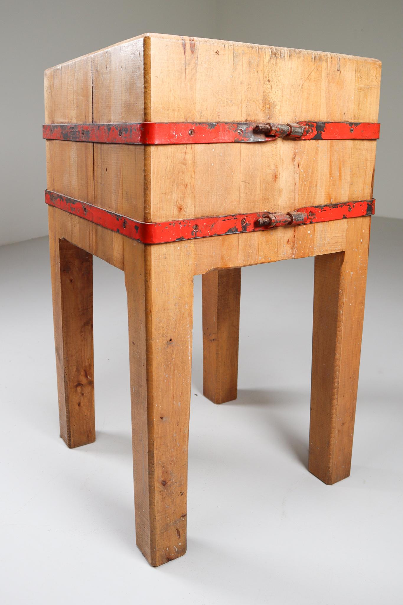 A handsome French butcher's chopping block or table, from the 19th century, featuring a large, square sloping block or slab of iron-bound wood set upon a four-legged support stand of beech.