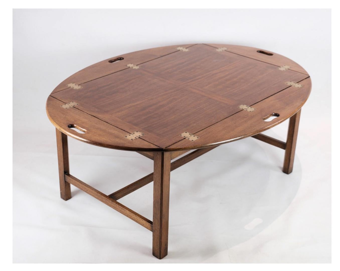 The butler table crafted from mahogany and dating back to the 1950s offers both elegance and functionality.

Constructed from mahogany, renowned for its rich tones and durability, this table exudes a timeless sophistication that complements various