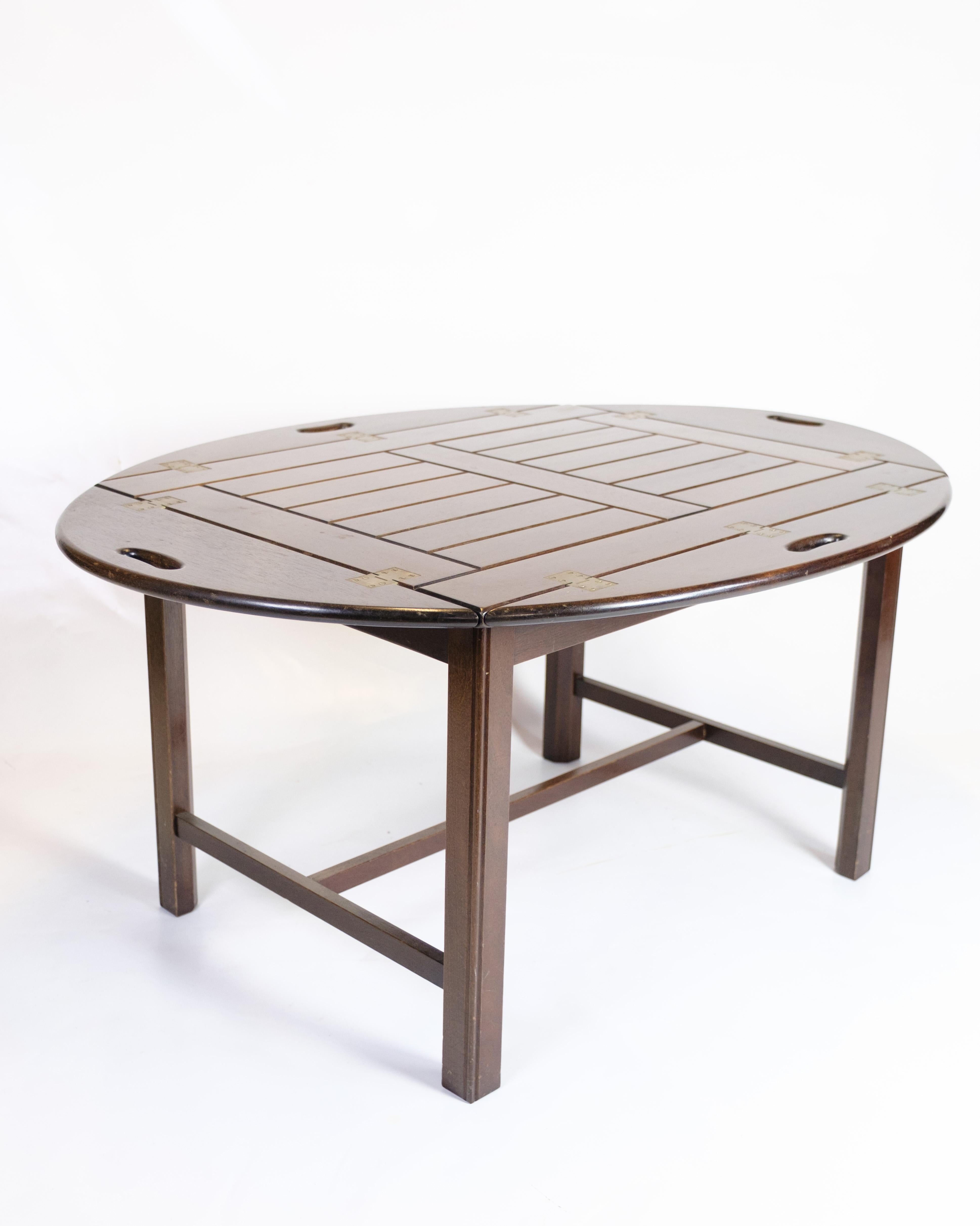 Mesa de mayordomo clásica de caoba con bandeja extraíble y patas plegables, típica del diseño danés de los años 60. La mesa combina funcionalidad con un diseño sencillo y es perfecta como mesa de servicio o mesa auxiliar.

Material:
