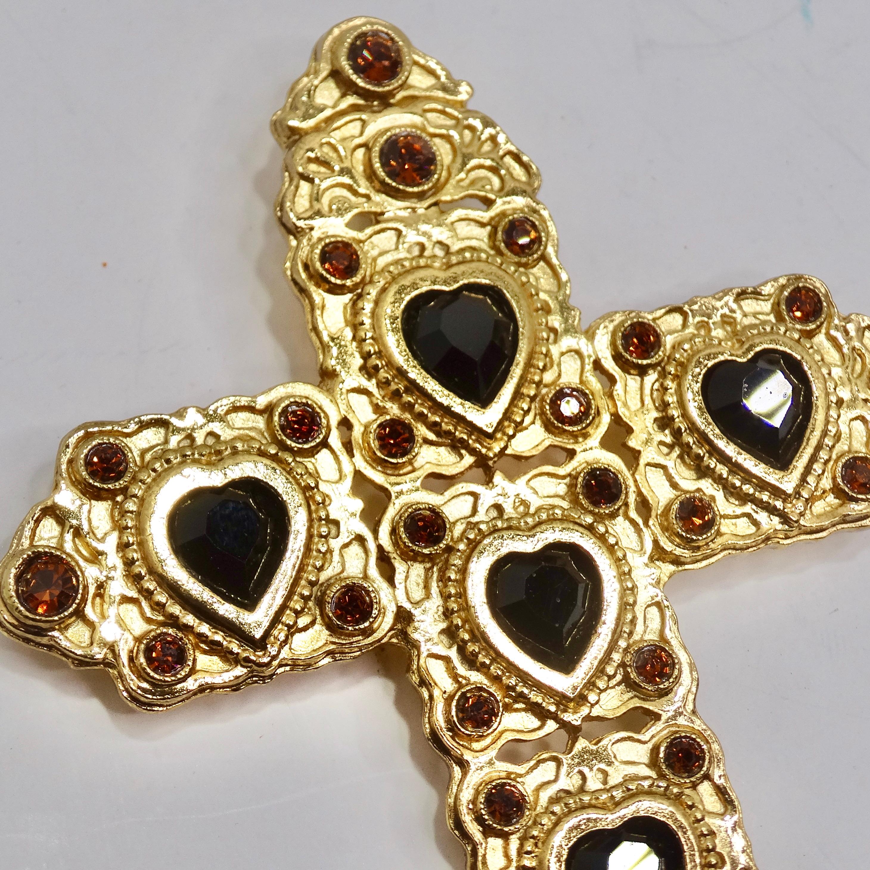Step into the world of vintage glamour with the Butler & Wilson 1980s Gold Tone Black Stone Cross Brooch. This stunning textured yellow gold brooch is a true testament to the iconic design sensibilities of the '80s, featuring a captivating cross