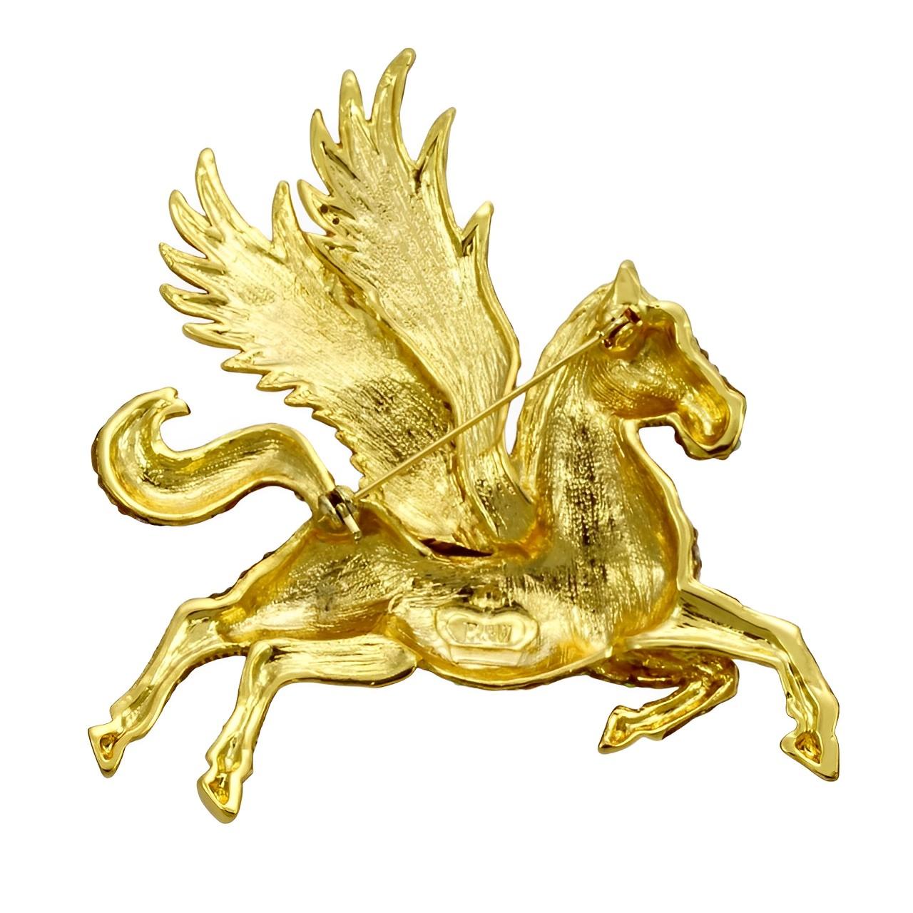 
Fabulous Butler & Wilson gold plated fantasy Pegasus brooch encrusted with gold aurora borealis crystals. It has a green crystal eye. Measuring maximum width 7.3 cm / 2.8 inches by maximum length 8 cm / 3.1 inches. The brooch is in very good