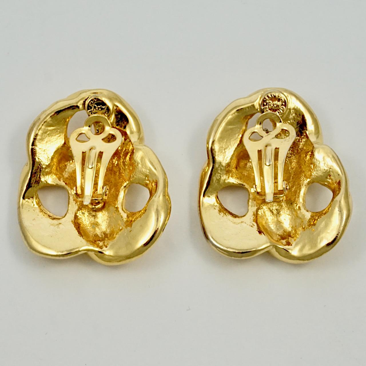 Glamorous Butler & Wilson gold plated clip on earrings with a triple twist ridged design. Measuring 3.3 cm / 1.3 inches by 2.9 cm / 1.14 inches.

This is a lovely pair of classic twist earrings, by London designers Butler & Wilson.

Nicky Butler and