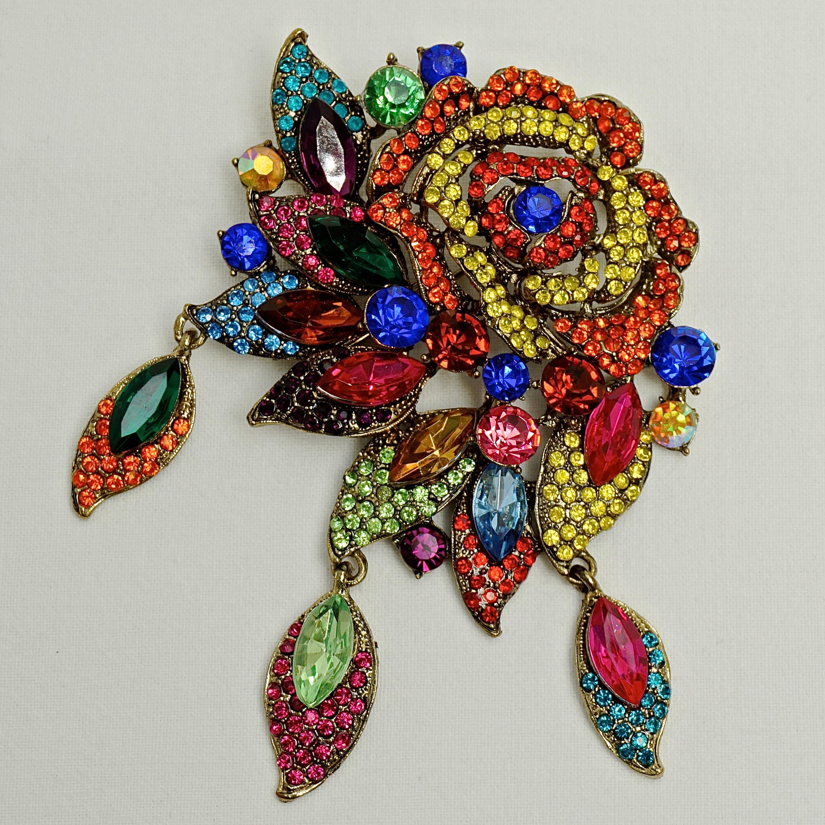 Large vintage Butler & Wilson gold tone flower and leaves brooch, with sparkling vibrant multi coloured crystals. Circa 1980s. Measuring length 10cm / 3.9 inches by width 6.5cm / 2.5 inches. The brooch will arrive in its original Butler & Wilson