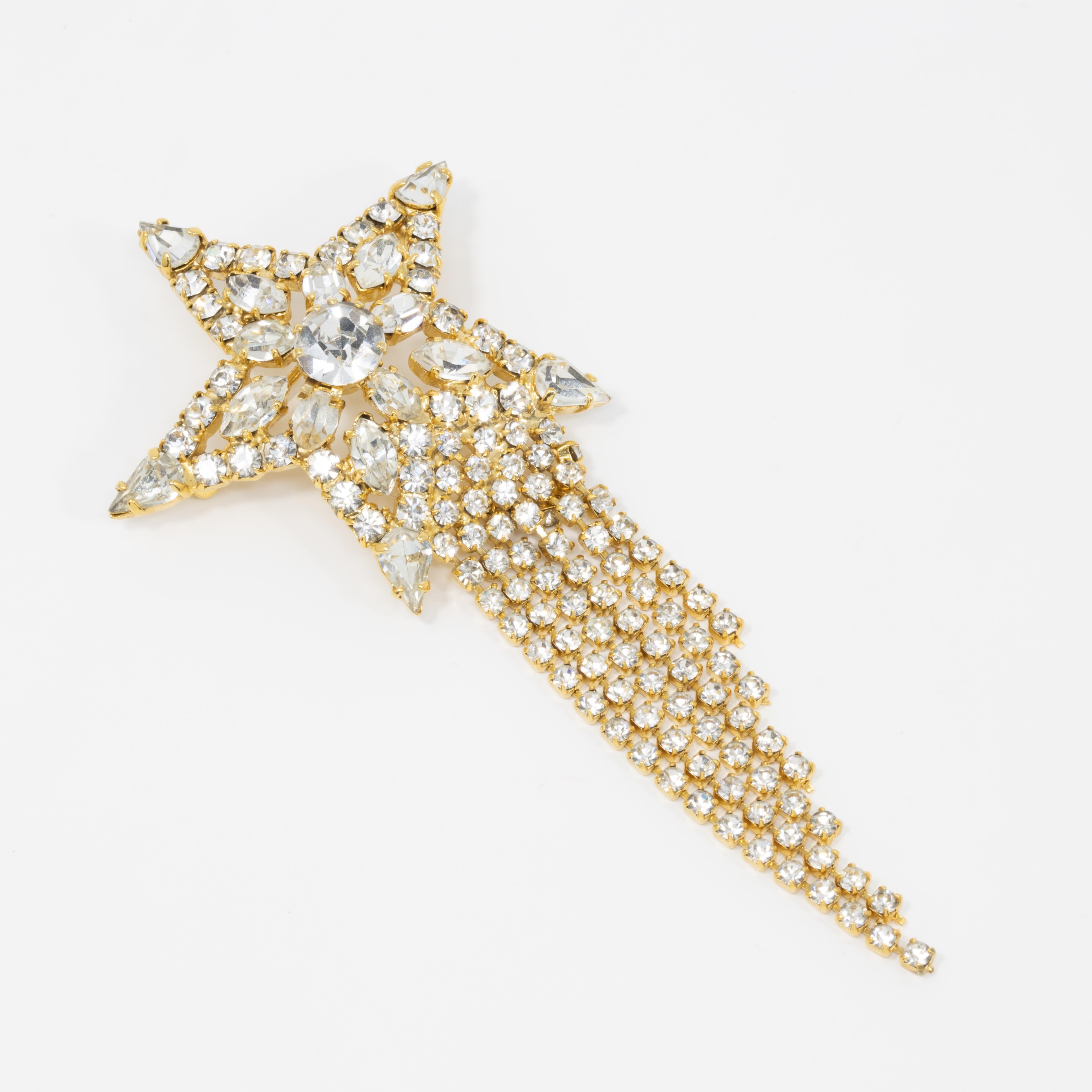 Vintage pin from mid to late 1900s, from UK-based costume jewelry designer Butler and Wilson. A sparkling, crystal-encrusted shooting star, accented with cascading tassels that add dazzling movement to the piece!

Hallmarks: B&W