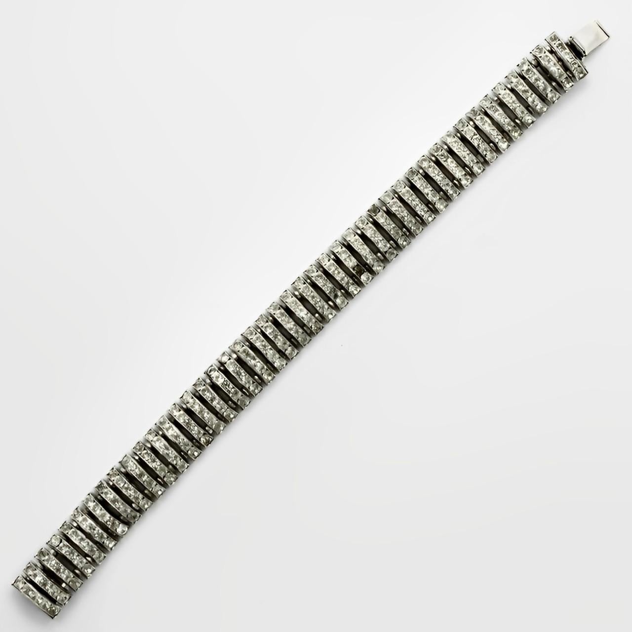 Wonderful Butler & Wilson silver tone link bracelet, featuring five rows of channel set crystals. The design is reminiscent of Art Deco 1930s jewellery made in Germany by companies such as Schreiber & Hiller. Measuring length 17.7 cm / 7 inches, by