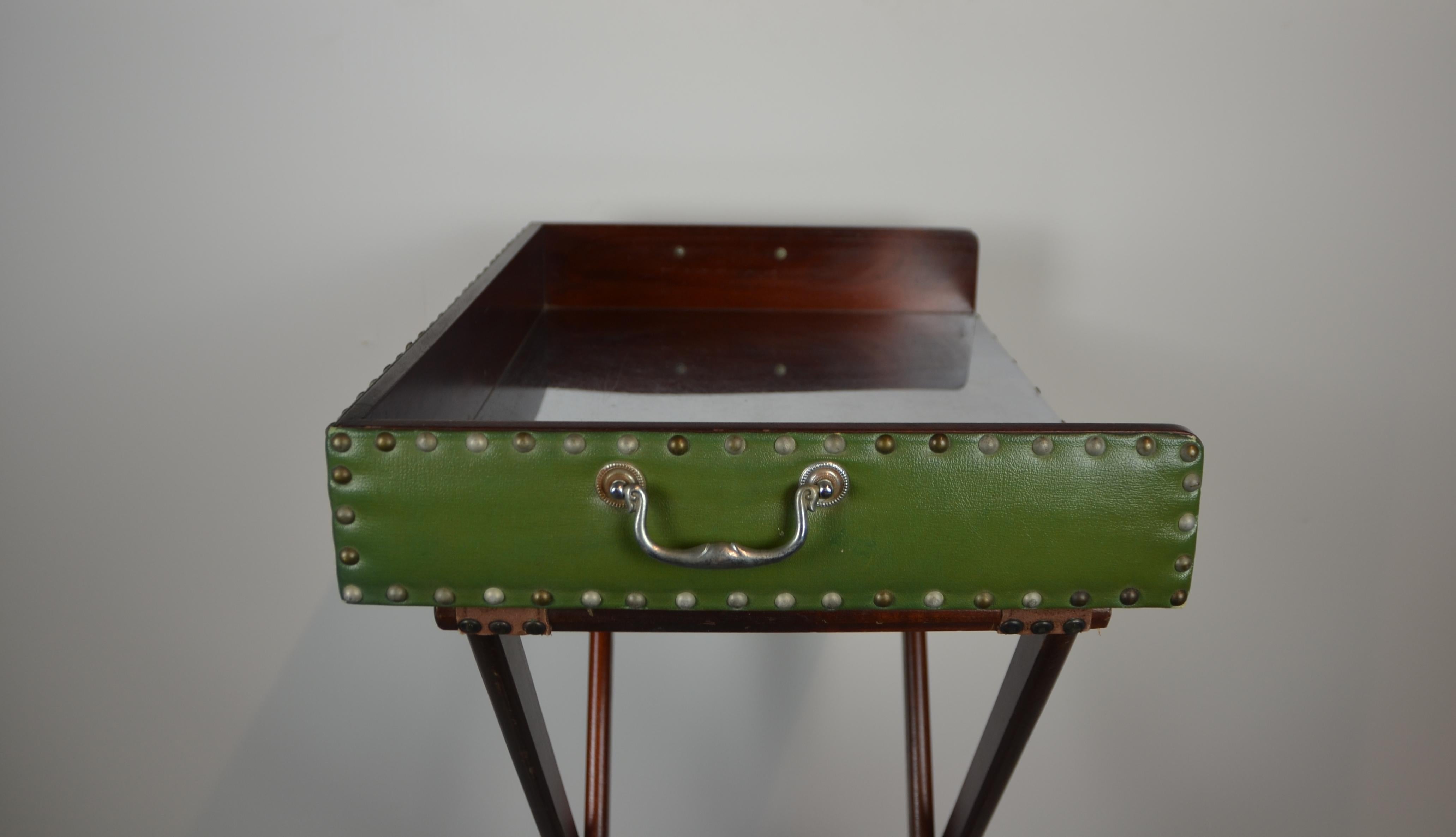 Butler's tray with stand. The sides are covered in green faux-leather and silver metal. The stand is mahogany with two straps.