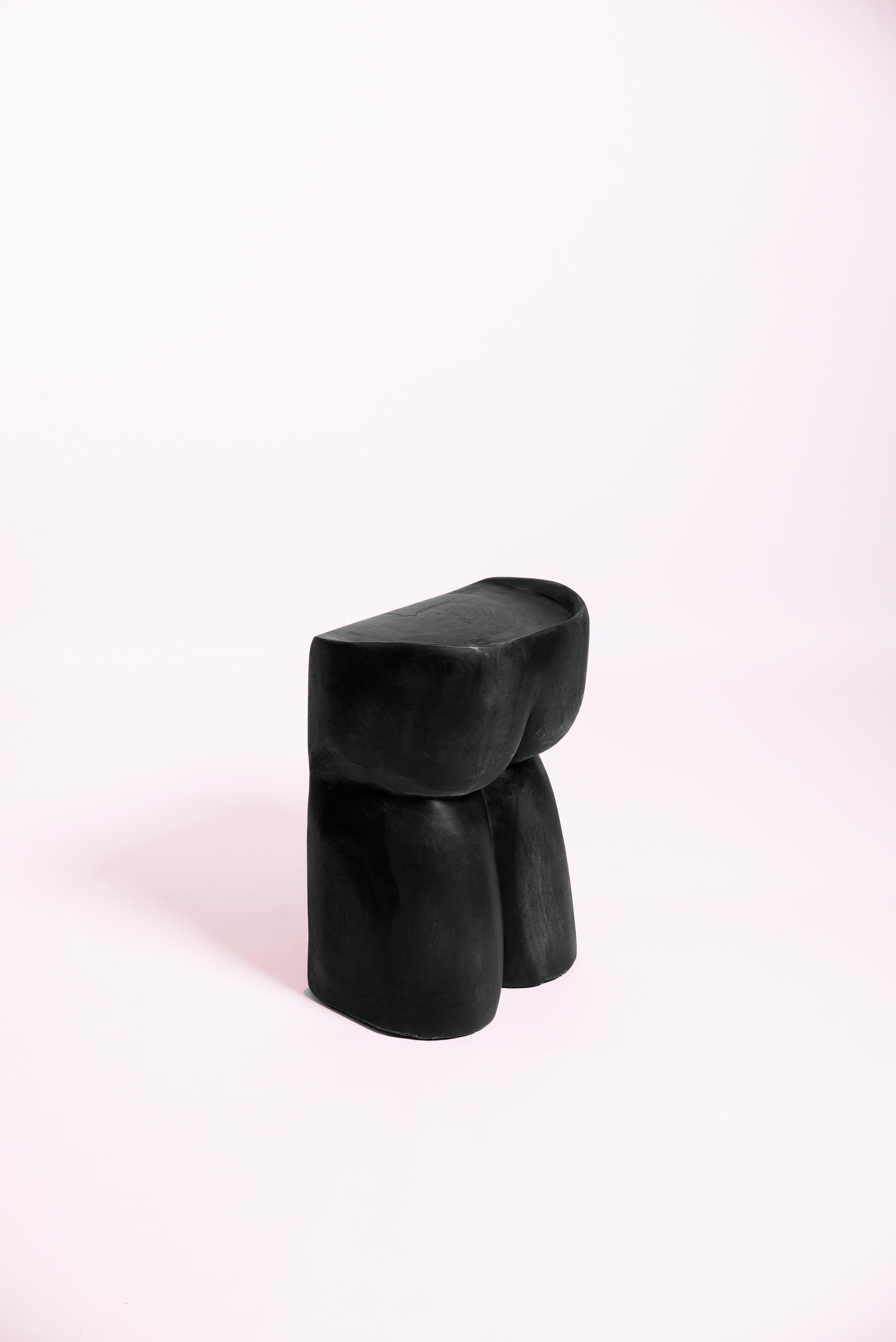 Solid wood stool sculpted by hand into a butt shape as a symbol of equality (we all have butts).